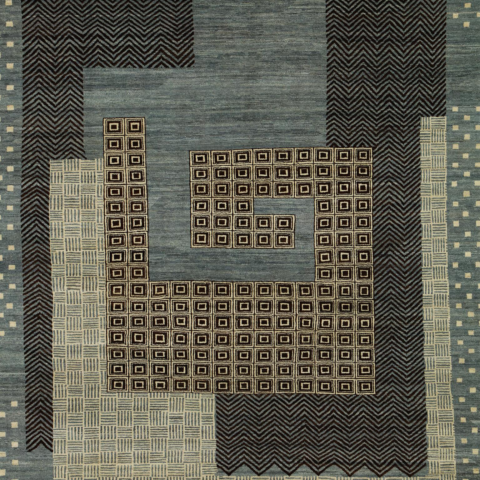 This blue, cream, gold, and black wool carpet with a modern architectural design, was woven using traditional weaving techniques from all-natural, hand-spun wool. Part of Orley Shabahang’s Architectural Collection, this piece titled “Labyrinth”