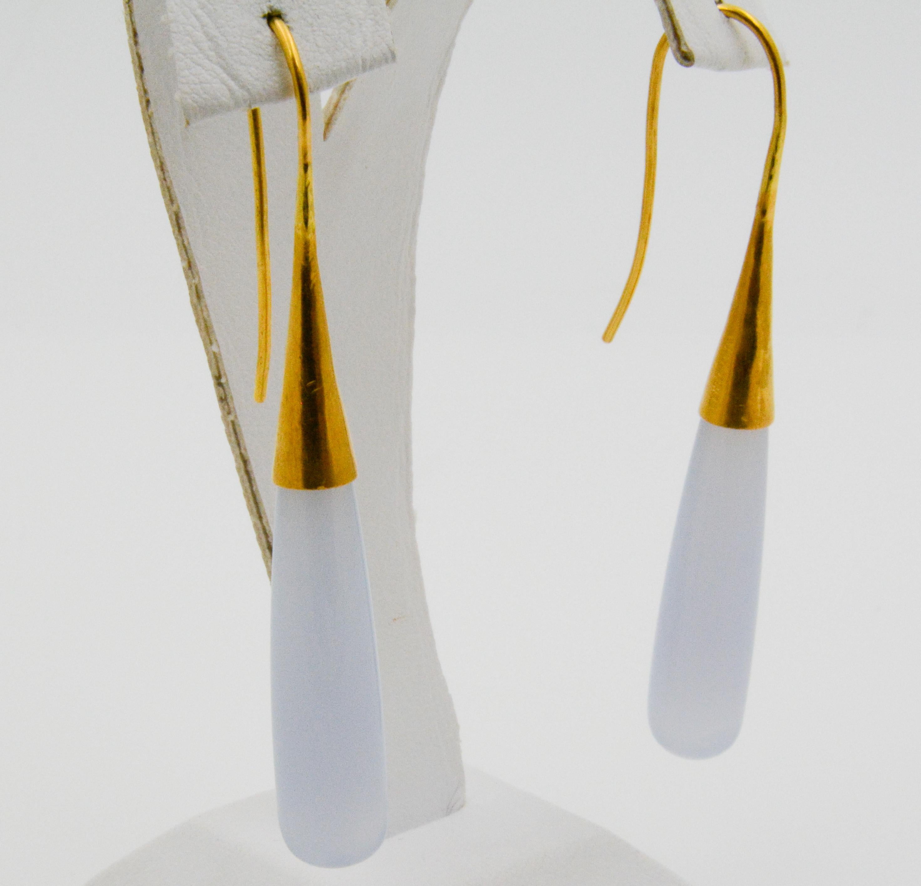 These contemporary 24k yellow gold drop earrings feature 38 x 8mm Chalcedony stones that have a slightly transparent sheen. 
