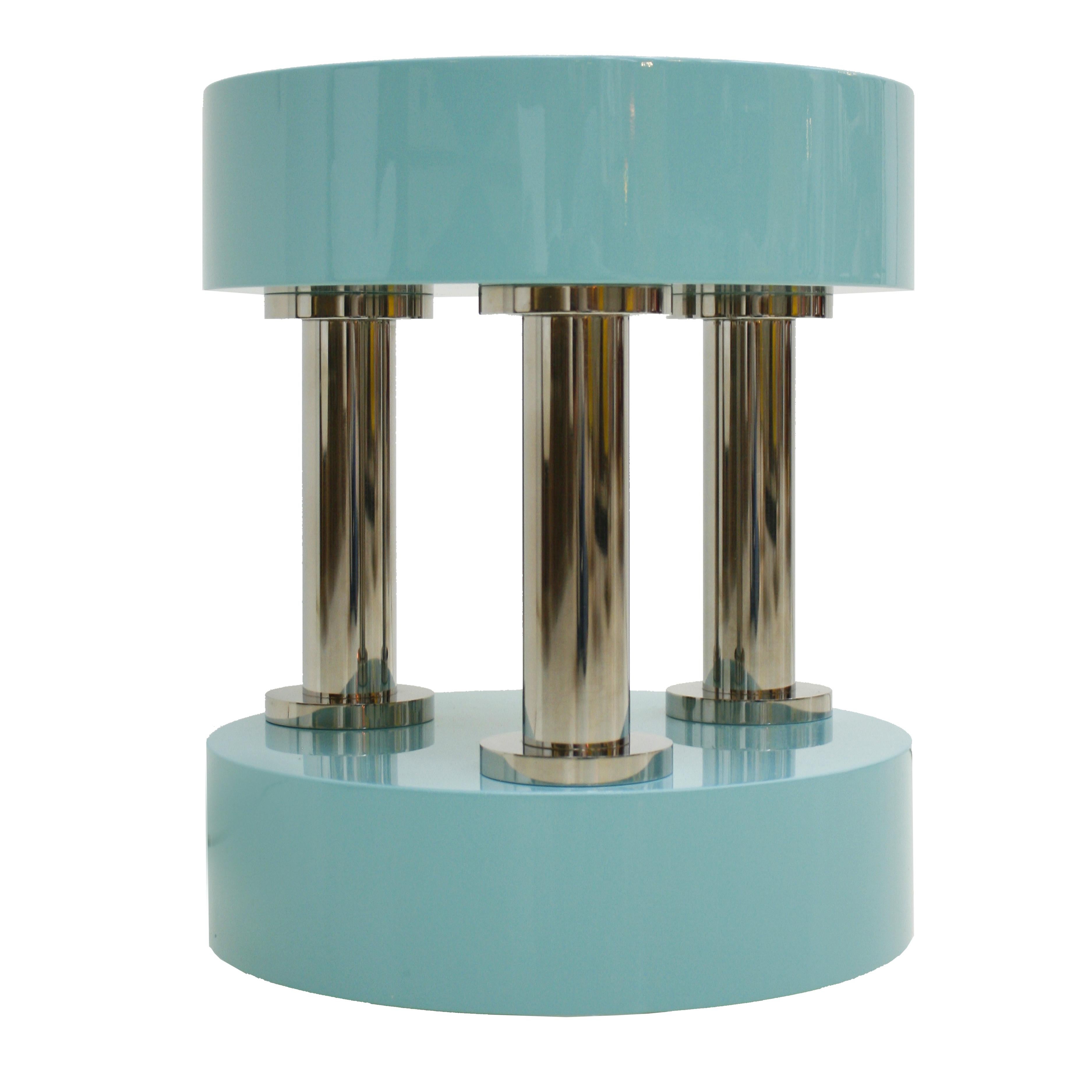 Modern circular German side table. Composed of top and base made of light blue lacquered solid wood fixed by three base tubes made of polished stainless steel. 
On the bottom base there are three ends where the client could add wheels to the table