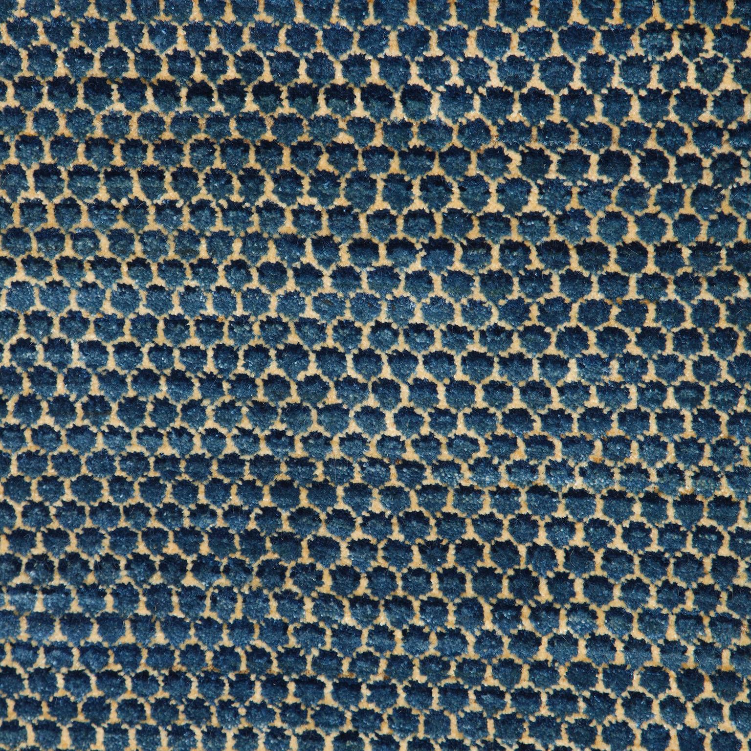 Aligned in a repetitive pattern, Droplet showcases a latticed fish scale pattern. Like all Orley Shabahang carpets, this piece utilizes a hand-knotted weave and organic vegetable dyes for its blue tones. Its small-scale design provides a detailed