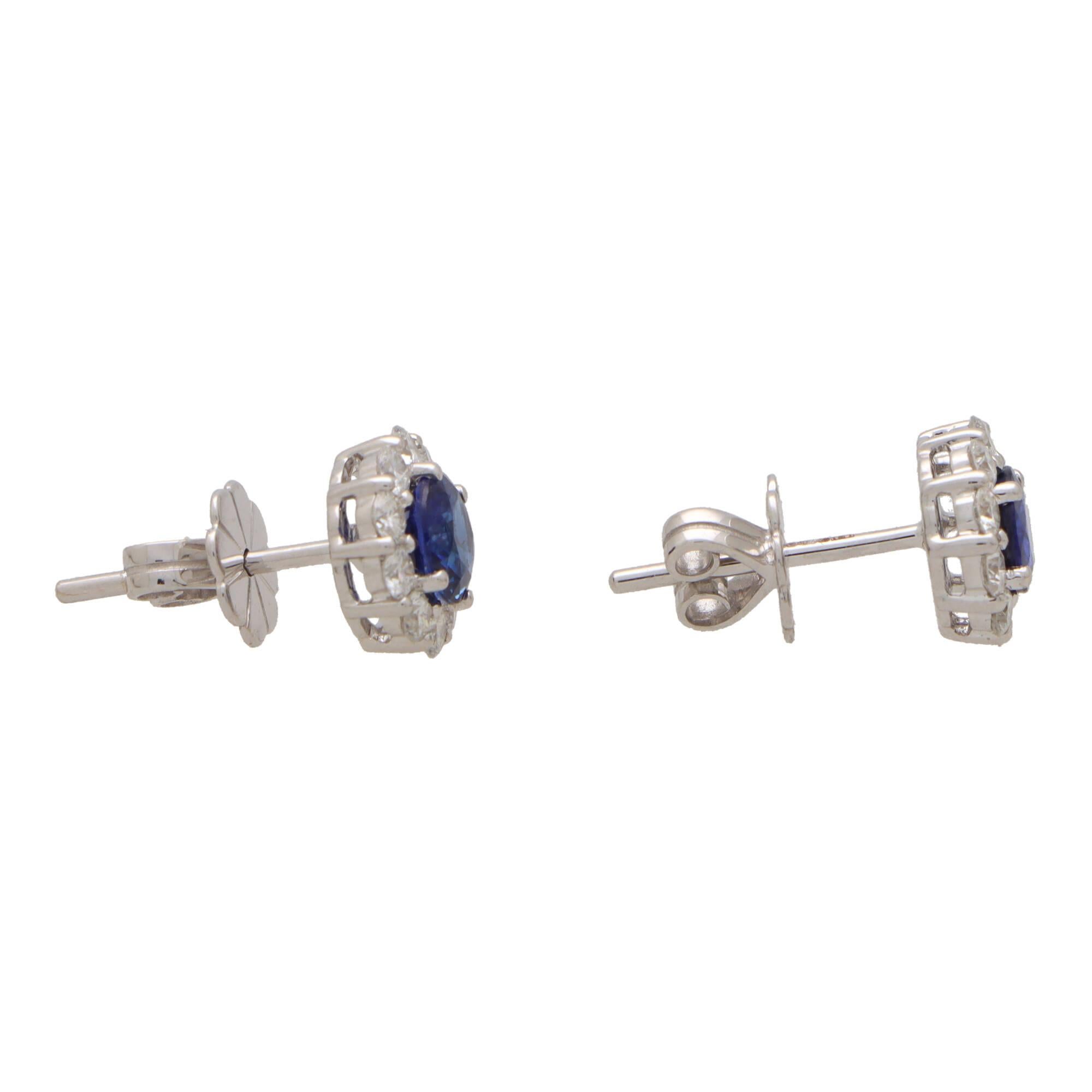 Round Cut Contemporary Blue Sapphire and Diamond Cluster Earrings in 18k White Gold For Sale