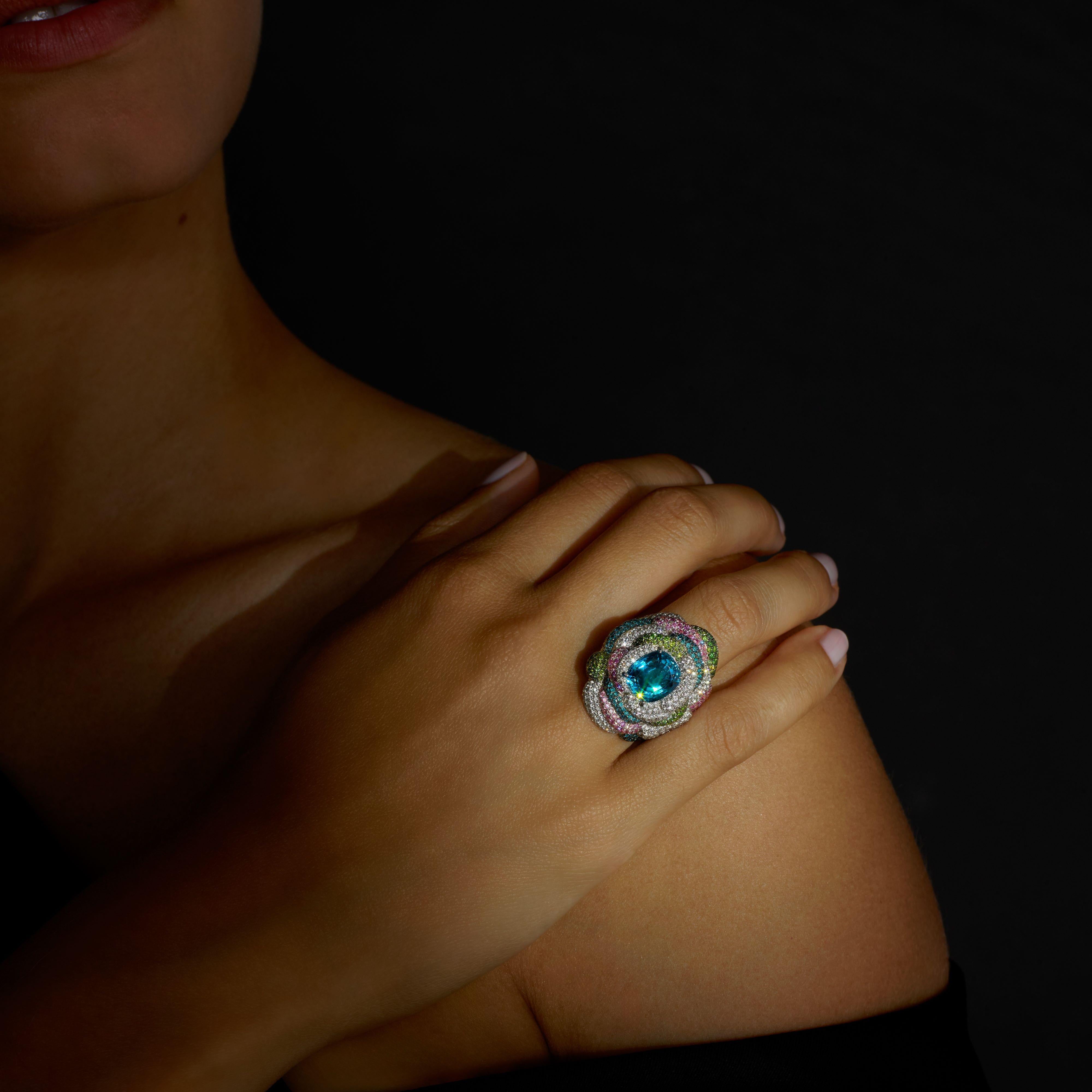 Rosior Contemporary Cocktail Ring set in White Gold with:
- 1 Cushion Cut Blue Zircon weighing 7,16 ct;
- 261 F Color, VVS Clarity Diamonds weighing 1,49 ct;
- 167 Green Diamonds weighing 1,08 ct;
- 124 Blue Diamonds weighing 0,81 ct;
- 147 Pink