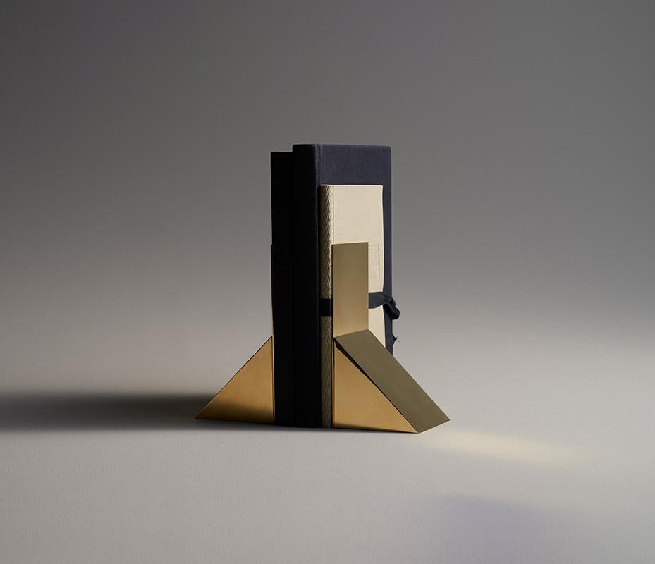 Heavy Book Ends in solid casted and polished brass. Casted in solid brass and polished. Small, minimal and elegant design but still heavy to hold your books. 2kg (4.4lbs) per book end.