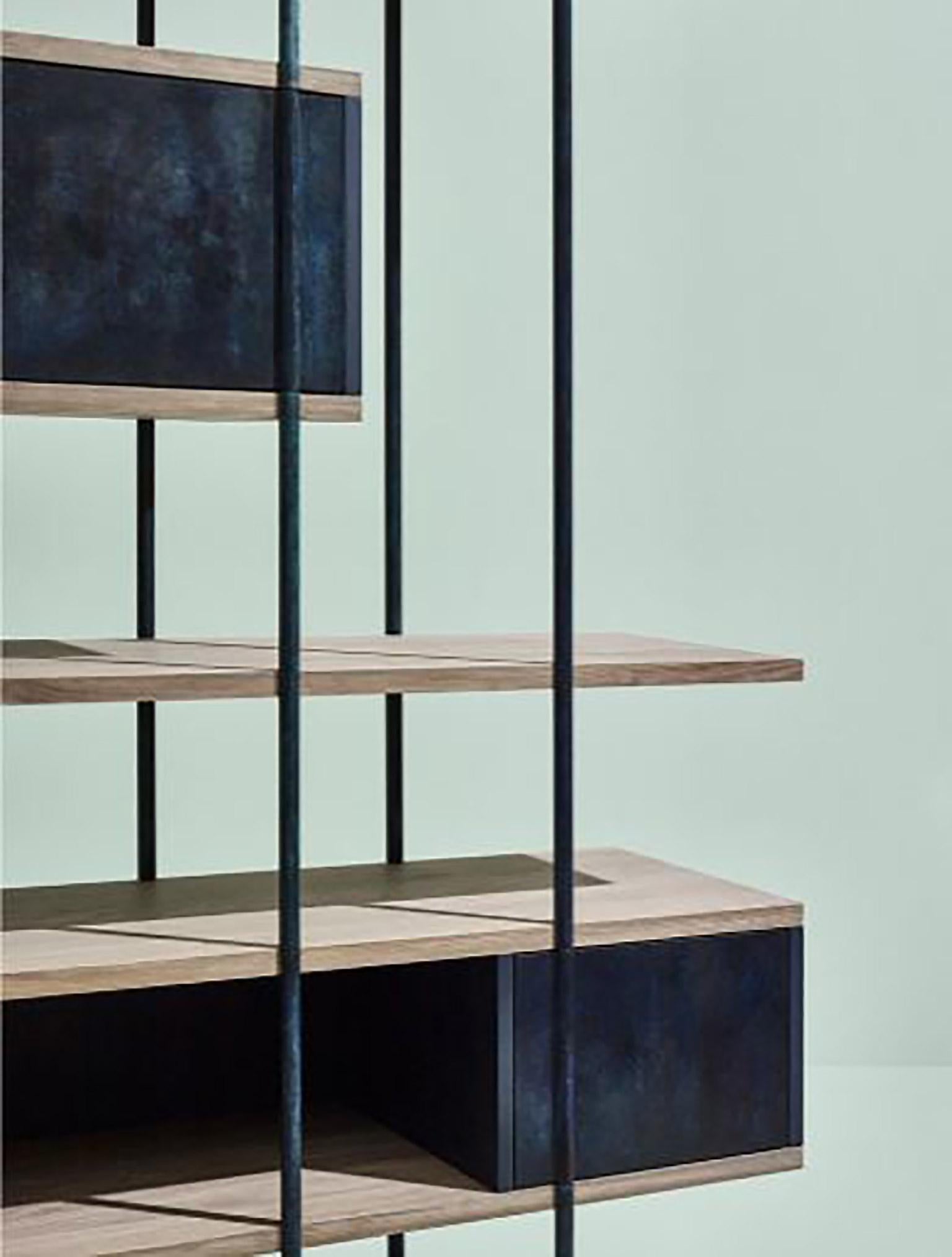 Sem Pivot collection, Bookcase A, simple and sculptural. The supporting structure is a rigid system of metal tubes to which are added shelves in beautiful stone elm wood combined with various lacquered containers .The pivoting mechanism for cupboard