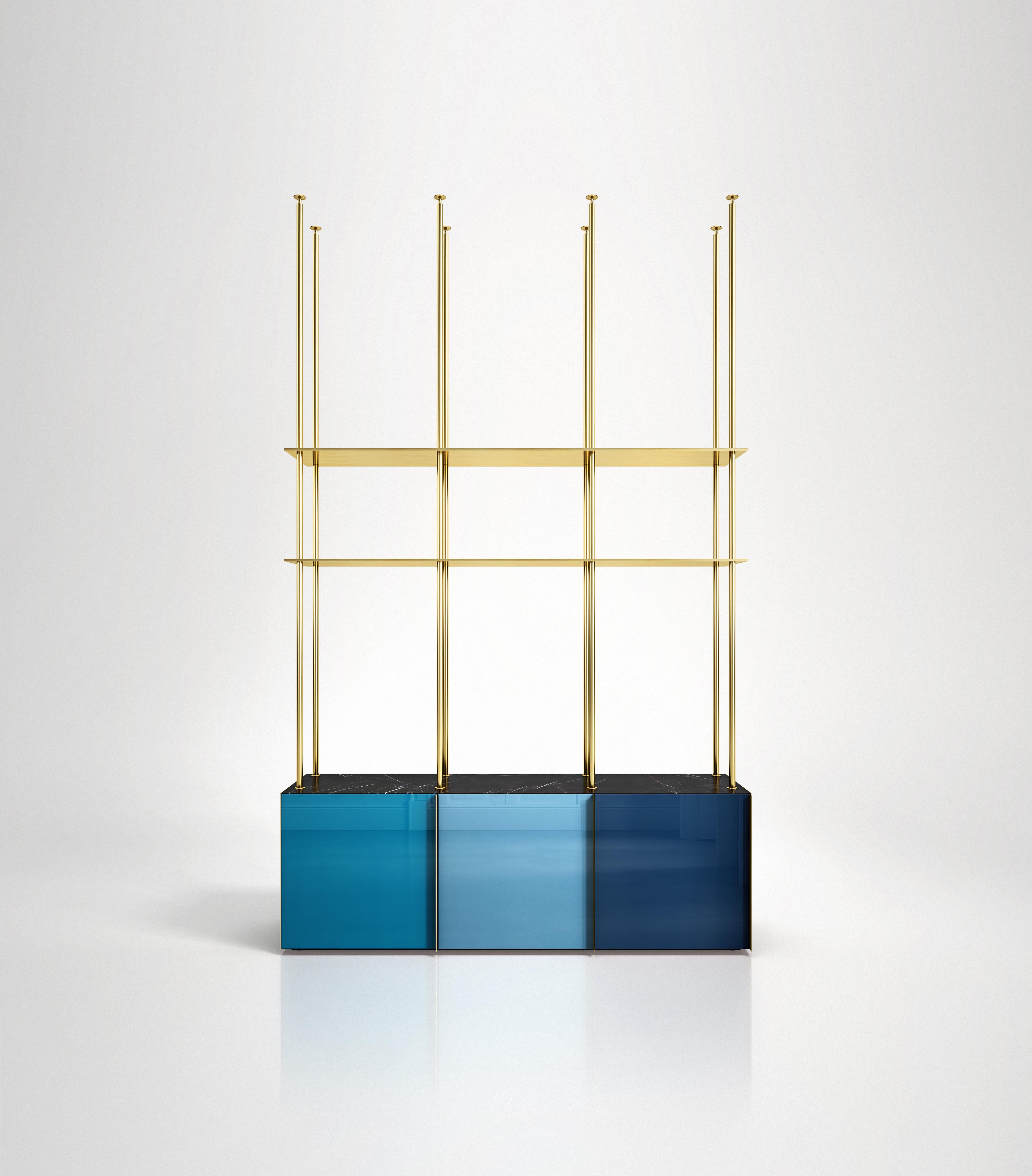 Bookcase 01
Floor to ceiling bookcase featuring 3 back-painted glass doors colored in cold tones, marble or onyx top, lacquered wooden interior and brass shelving. Each of the three doors has a vertical brass handle and each compartment has an