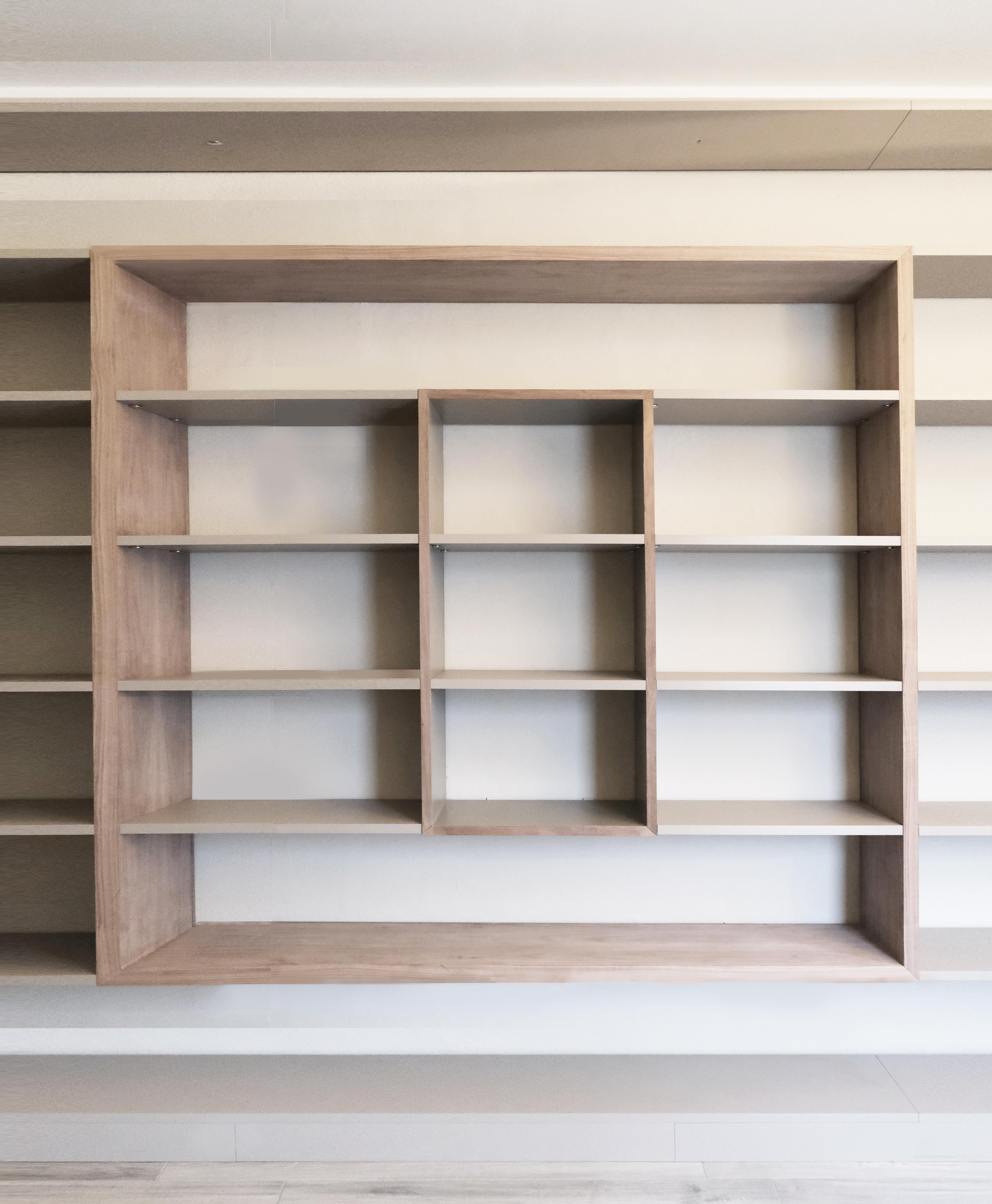 Minimalist contemporary bookcase Frame  built with precious canaletto walnut board. For Sale