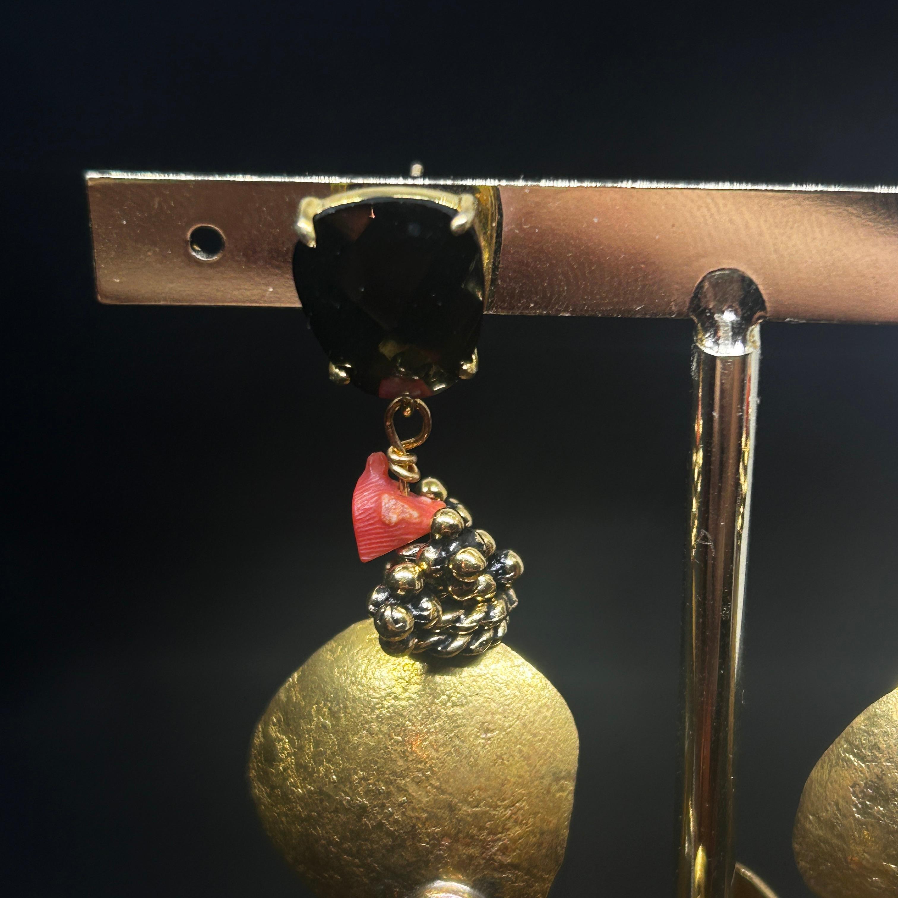 The combination of brass, coral, and other gemstones makes these earrings a striking mix of elegance and whimsical marine inspiration, perfect for someone looking for a statement piece with artistic flair.
The earrings feature octopus shapes crafted
