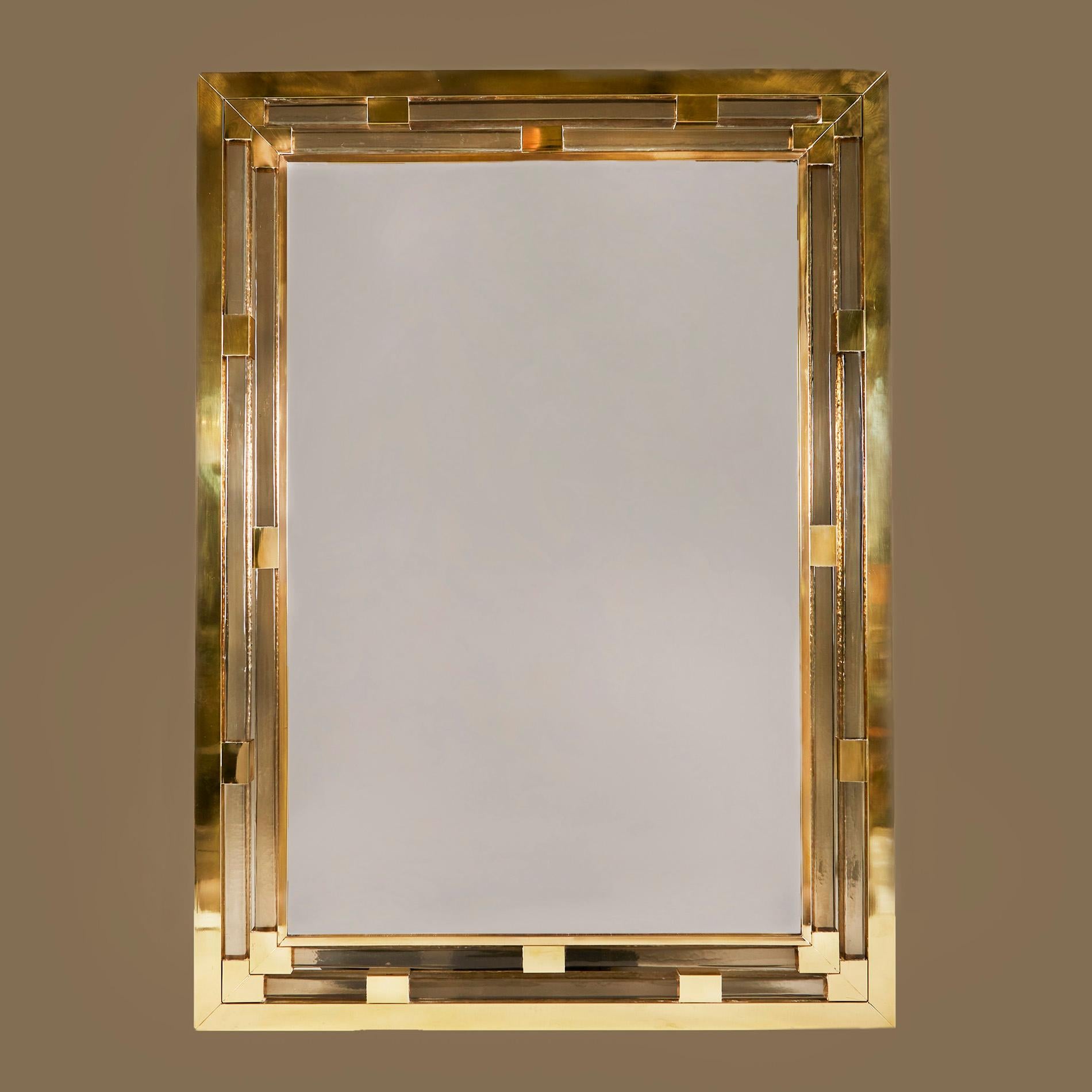 Substantial contemporary Italian rectangular mirror in a midcentury Italian style. The triple brass frame is interspersed with two chunky layers of Murano square glass in a subtle champagne shade. The design incorporates brass corners and brass