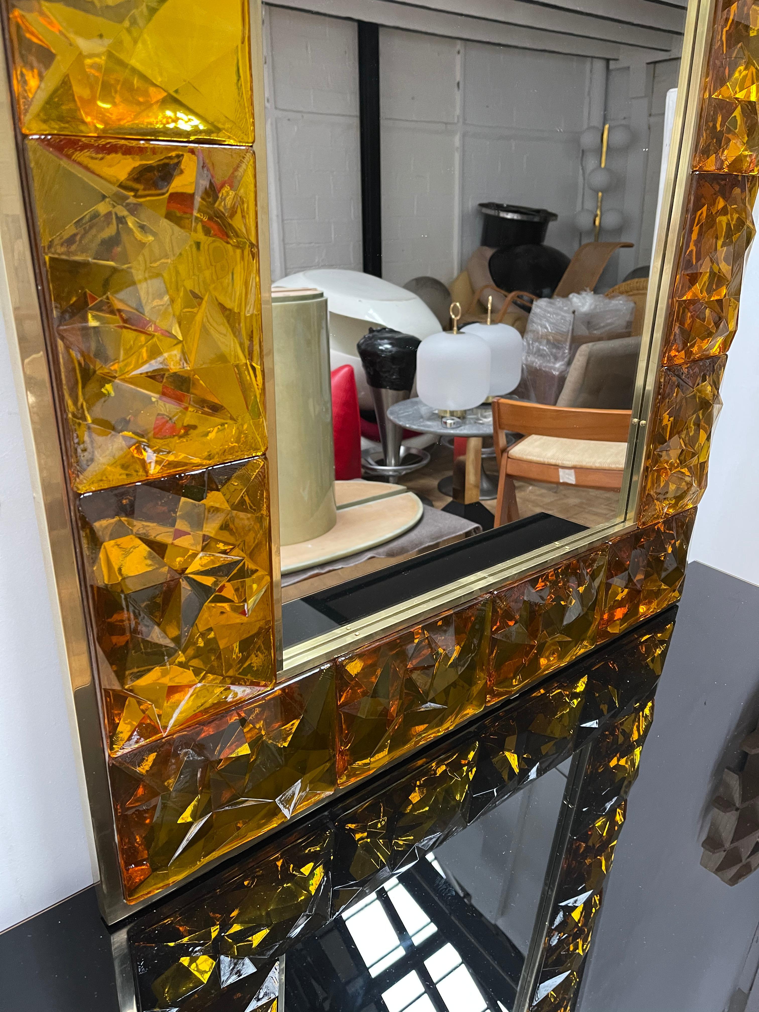 Contemporary wall mirror, full brass and large pieces of Amber murano glass with relief diamond point. Small artisanal workshop. The mirror can be hang horizontally also.