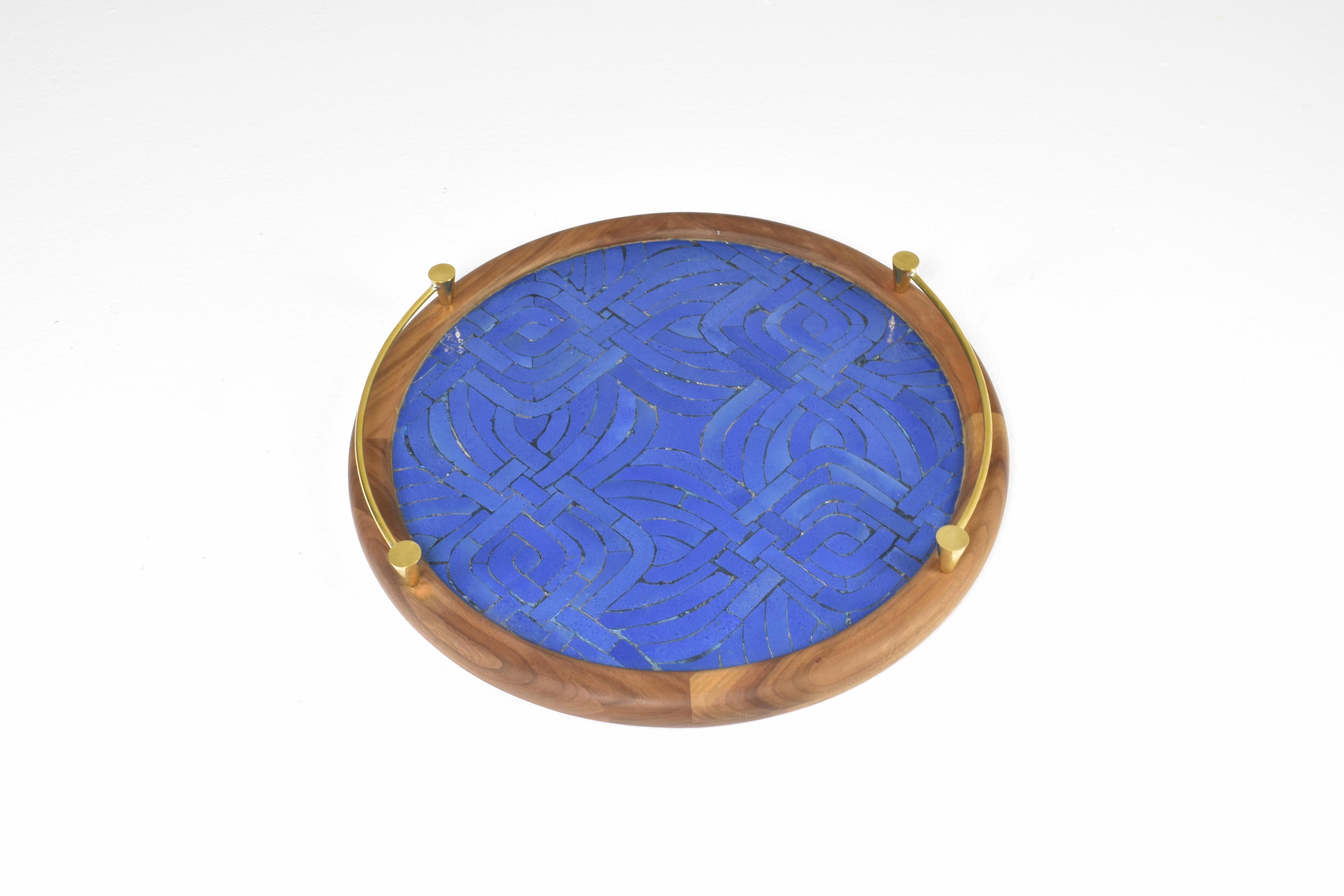A contemporary handcrafted tray composed of a handmade mosaic Moroccan zellige surface, a walnut frame and polished elegant brass handles.
Designed by Jonathan Amar at his atelier in Rabat

This piece is meticulously handcrafted, imbuing it with a