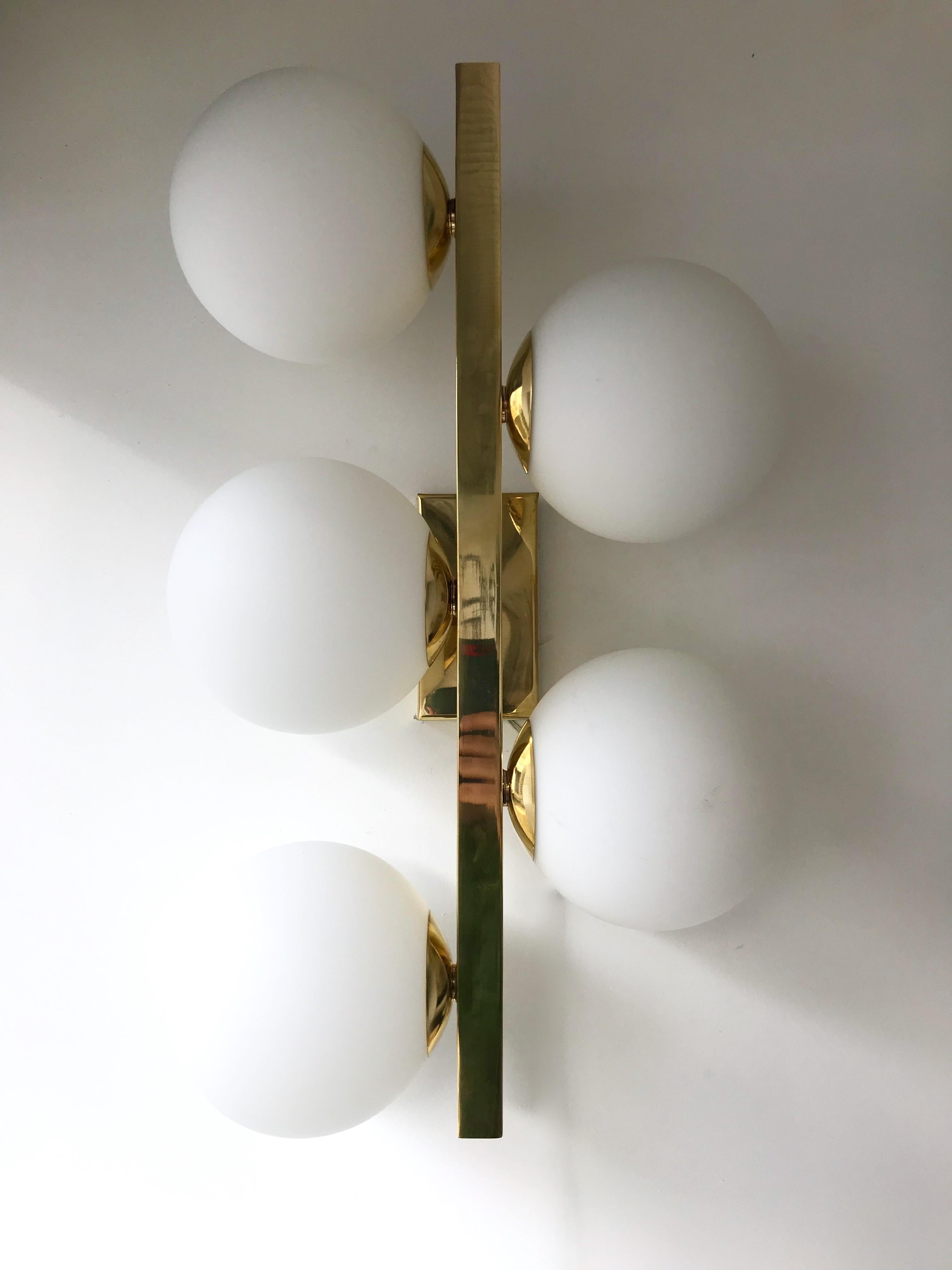Contemporary gilt brass wall lights sconces, blown Murano opaline glass ball. Few exclusive artisanal production. In the style of Stilnovo, Lumi, La Murrina, Mazzega, Aldo Carlo Nason.