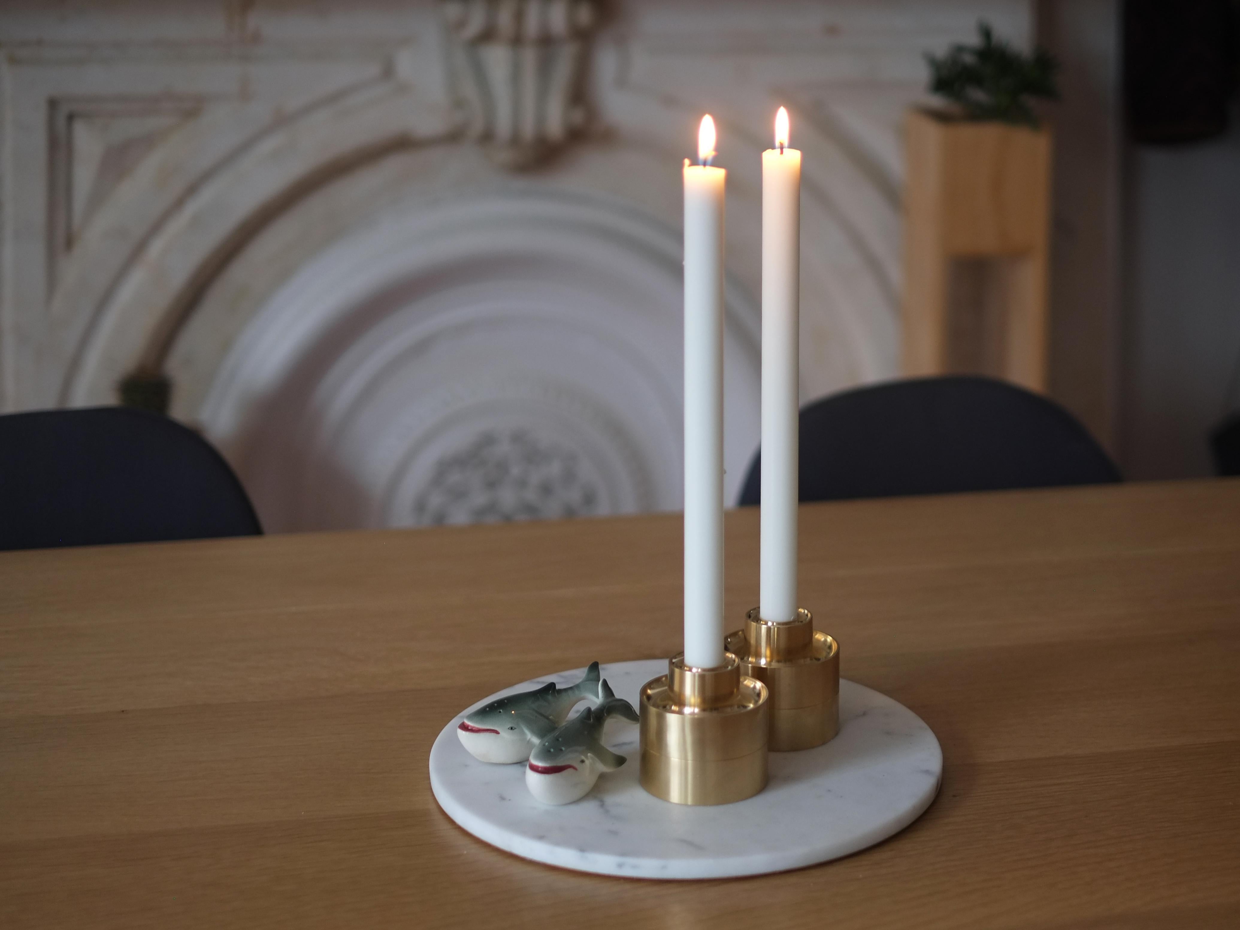 Stack and flip these solid brass candle holders to light up any room.

Machined from a solid billet of brass, the Stacking Candle Holders demonstrate the impressive weight of brass and the precision finish of the tool used to form them. Designed