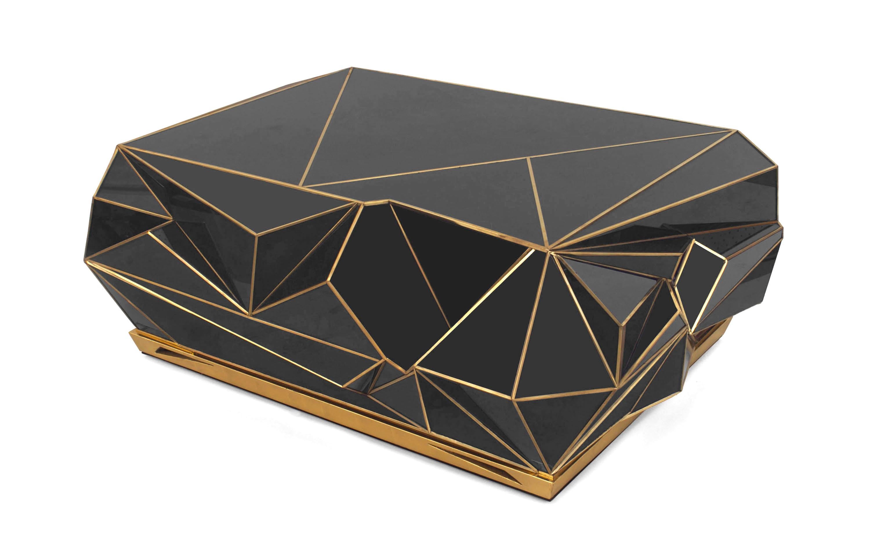 American Modern design rectangular geometric faceted form black glass coffee table with brass detailing and a giltwood base.
