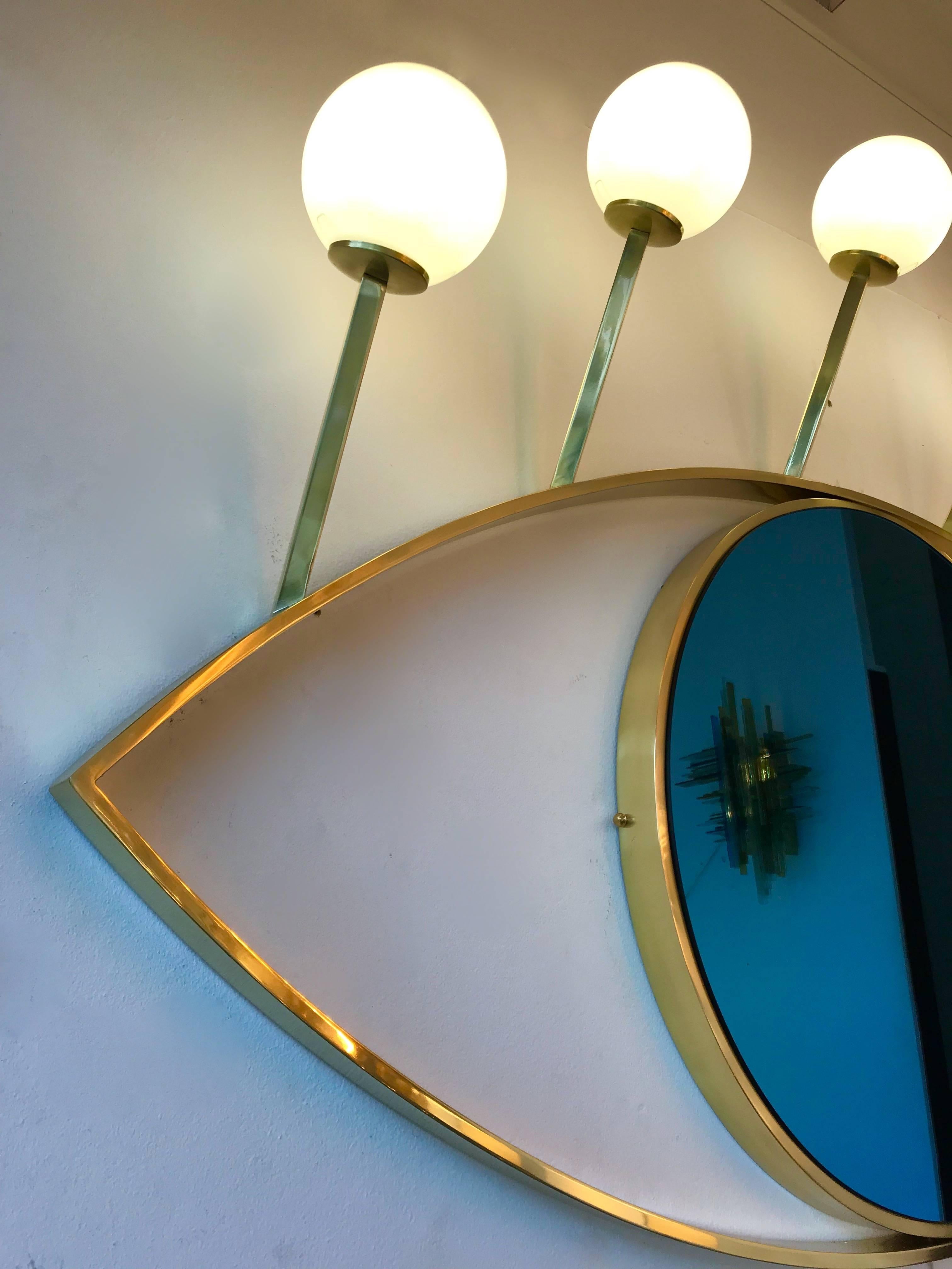 Blue eyes full brass lightning mirror with sconces. Opaline glass ball. Few exclusive production on order from a small artisanal Italian workshop.