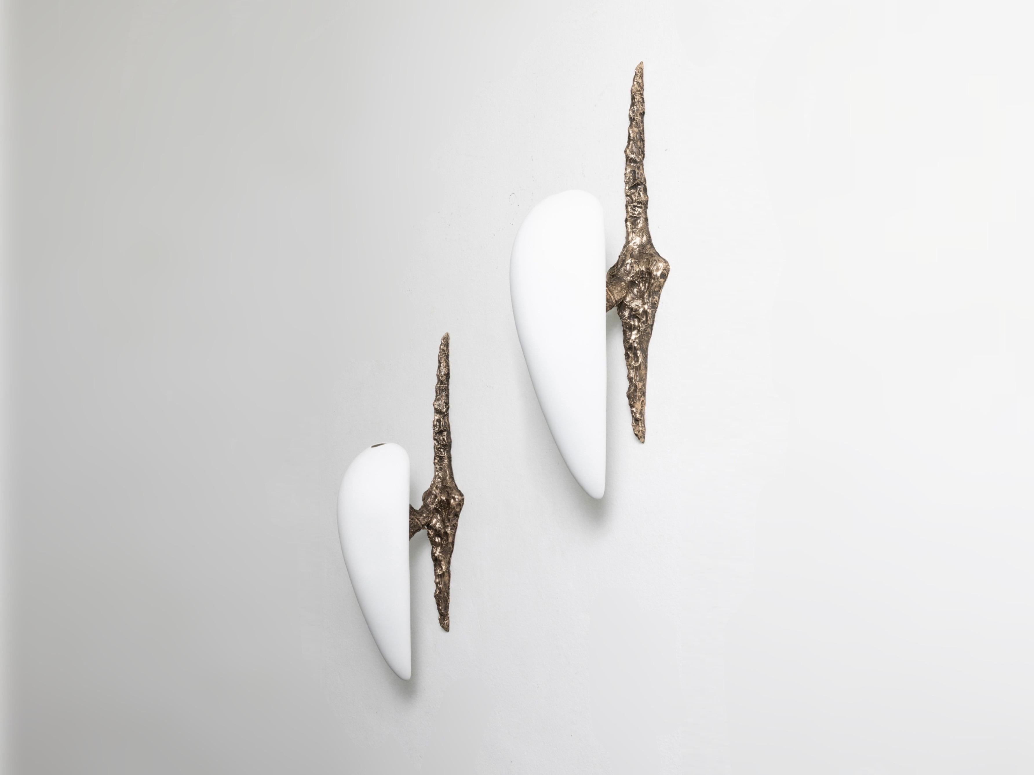 Sconces by William Guillon
Material: Patinated and polish bronze, porcelain shade 
Dimensions: H 80 x 45 cm
Year: 2023

Resulting from bronze and porcelain, each piece is unique and hand-sculpted from scratch in wax before being cast. We offer a new