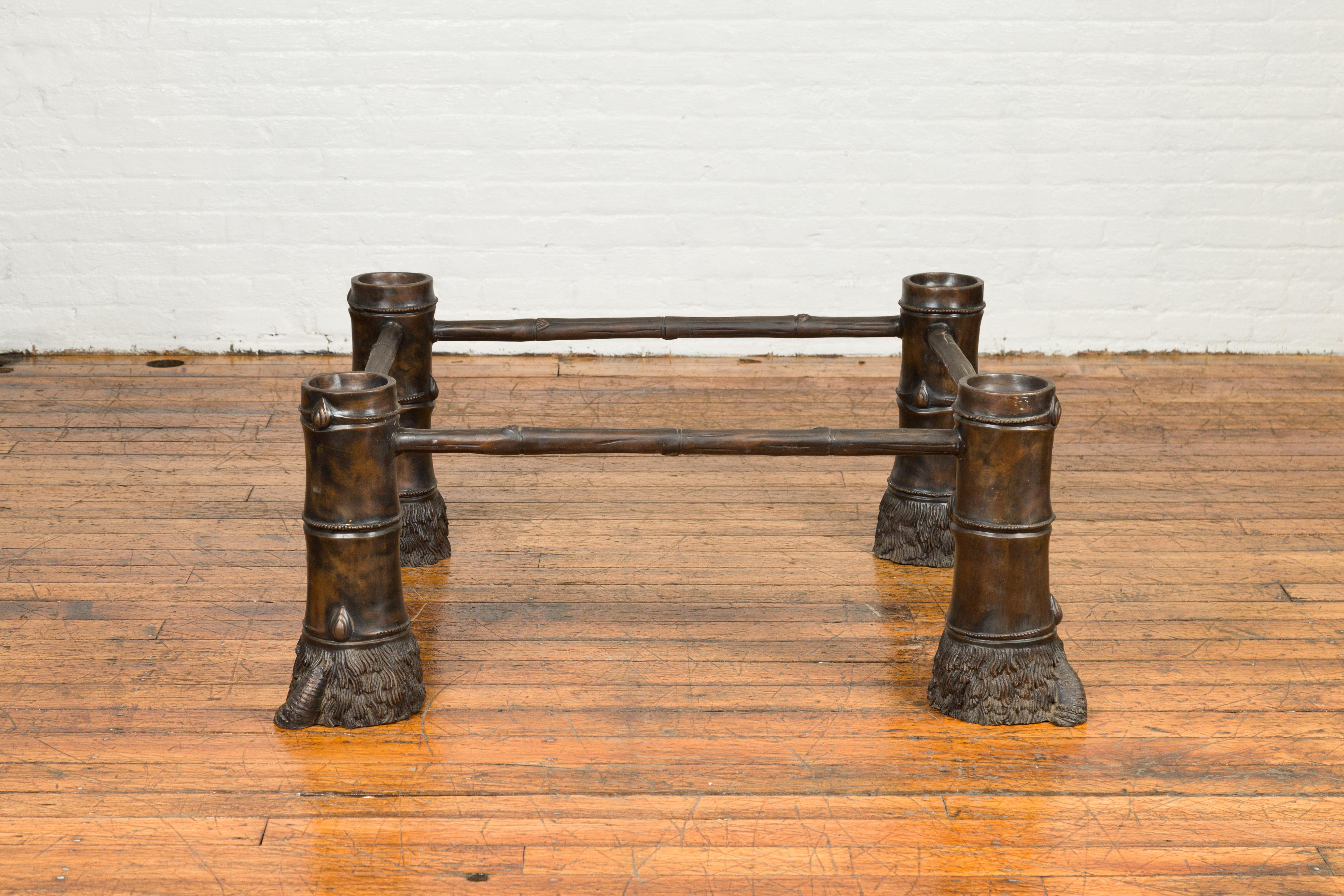 A contemporary bronze coffee table base with hoofed feet. Created with the traditional technique of the lost-wax (à la cire perdue) that allows a great precision and finesse in the details, this bronze coffee table base features four large and