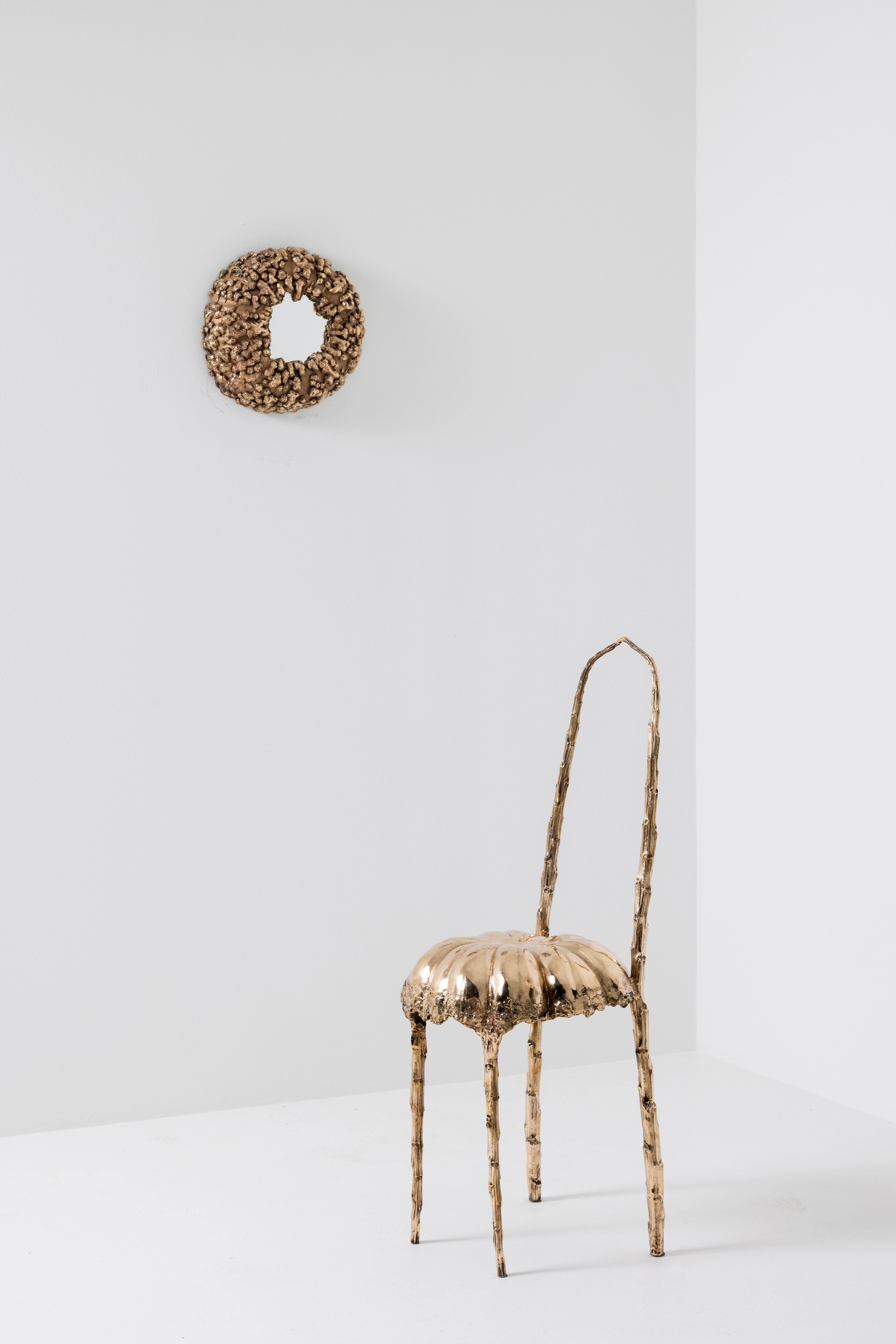“Jellyfish” chair by Clotilde Ancarani 
Material: Bronze, golden polish
Dimensions: H 80 x Ø 38 cm
Year: 2023

The “Jellyfish” bronze chair by Clotilde Ancarani is moulded and cast to simulate the organic suppleness of natural elements combined
