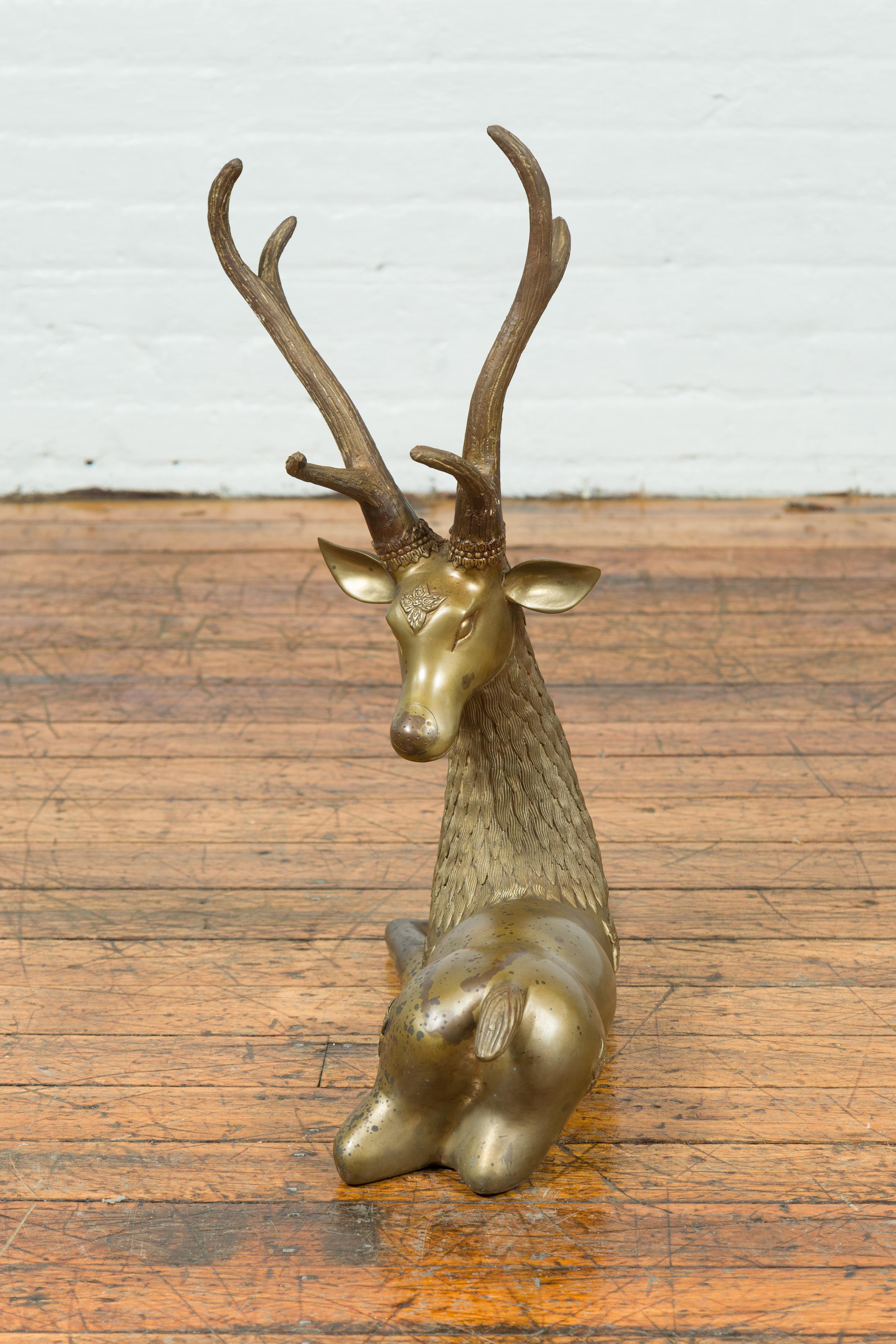 Cast Contemporary Bronze Reclining Deer Statue with Golden Patina and Large Antlers