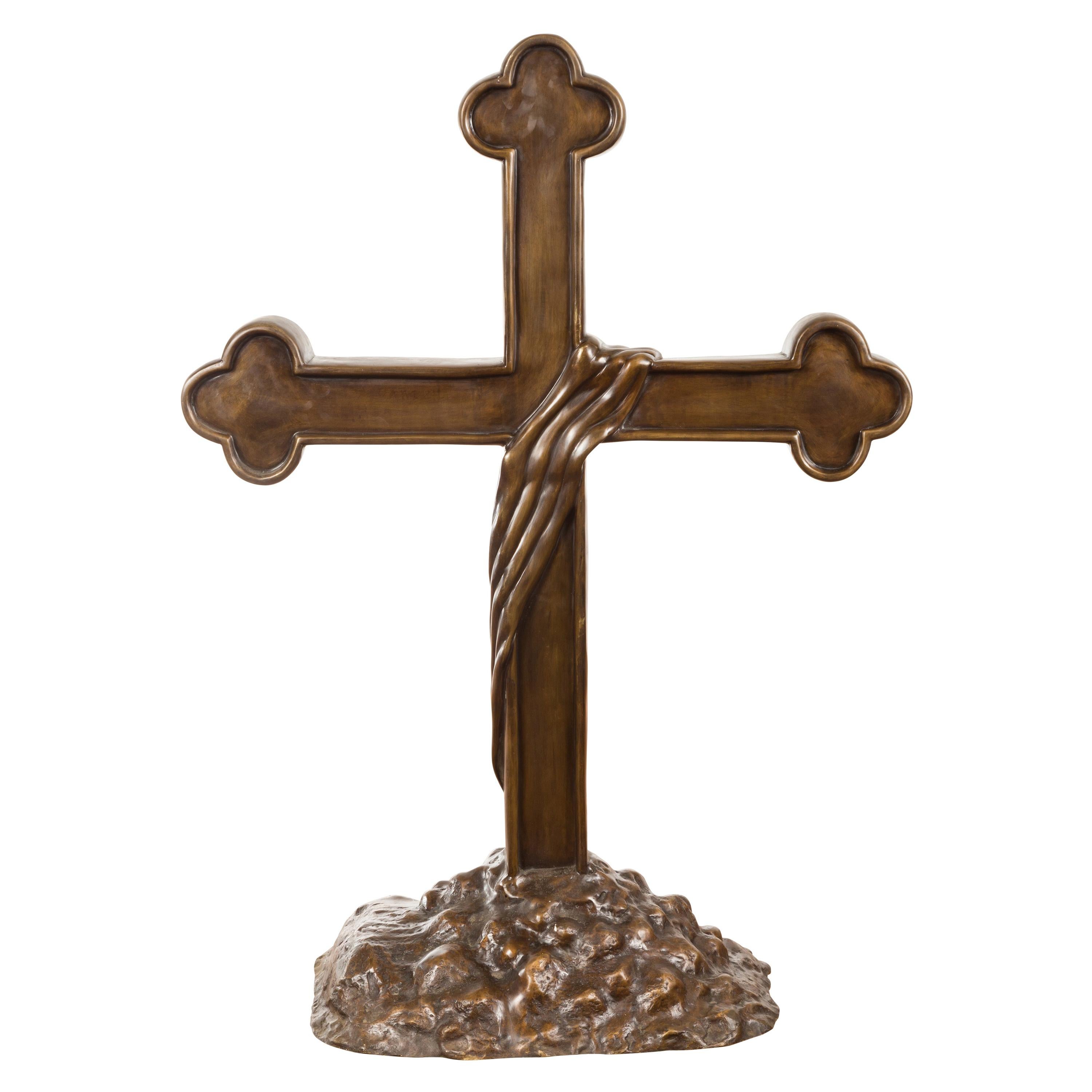 Contemporary Bronze Religious Cross with Trifold Extremities and Rocky Base For Sale