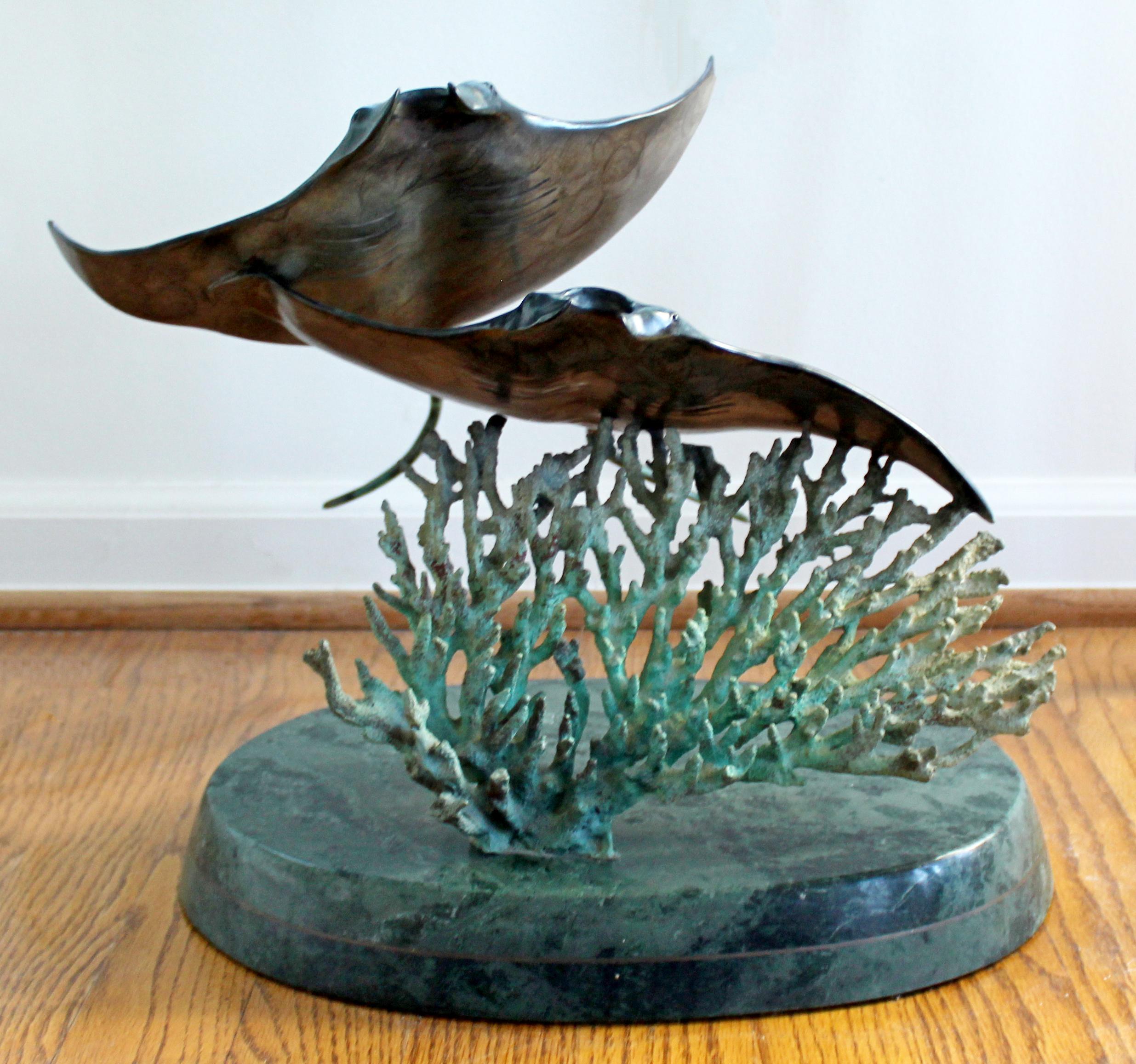 For your consideration is an incredible, bronze floor sculpture of a pair of manta rays, signed Wyland, numbered 40/300, circa 1991. In excellent condition. The dimensions are 17