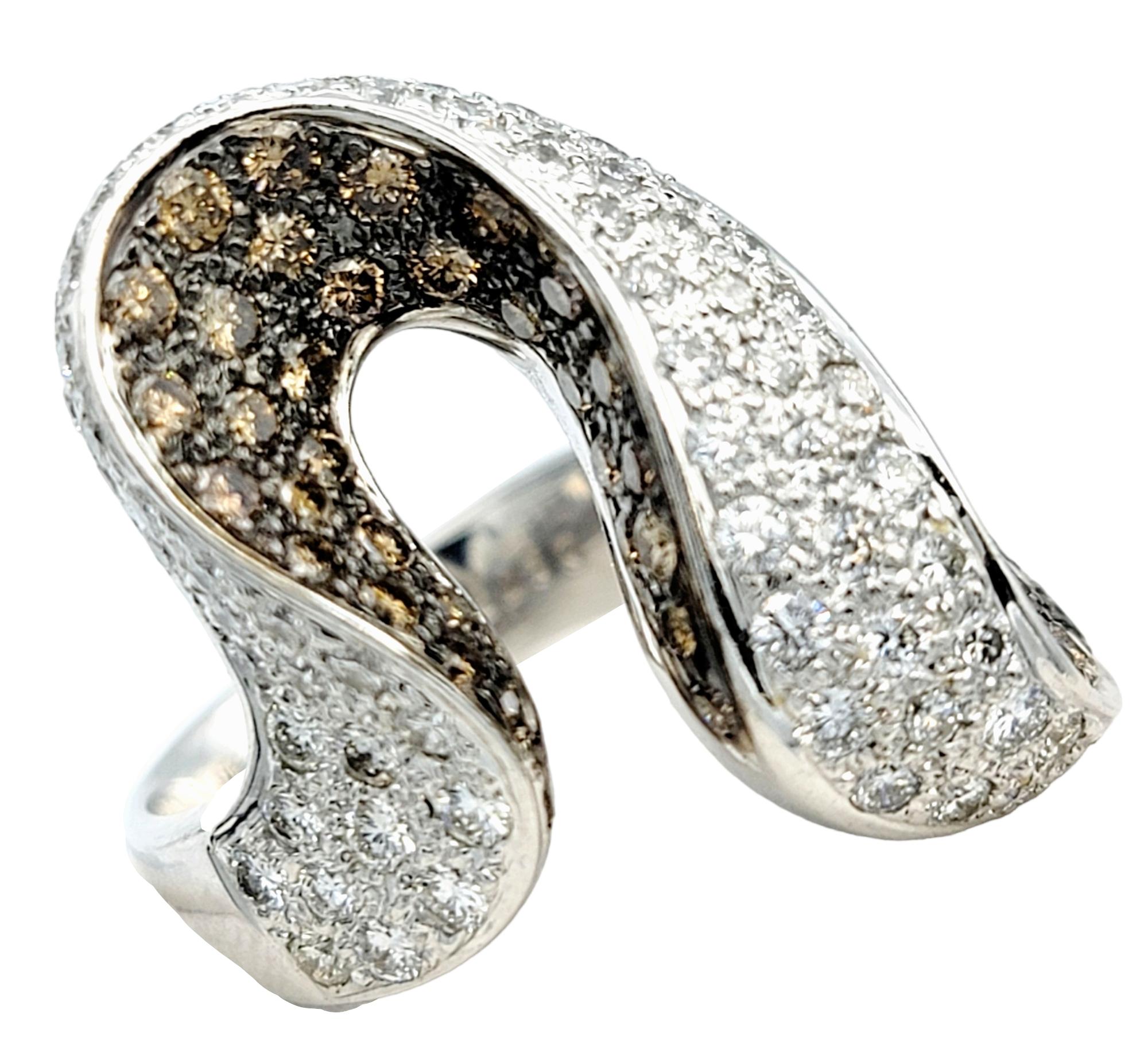 Ring size: 6.75

Shown here is a captivating masterpiece that seamlessly blends modern design with timeless luxury - our contemporary pave diamond asymmetric swirl cocktail ring. Crafted in luxurious 18 karat white gold, this ring is a striking
