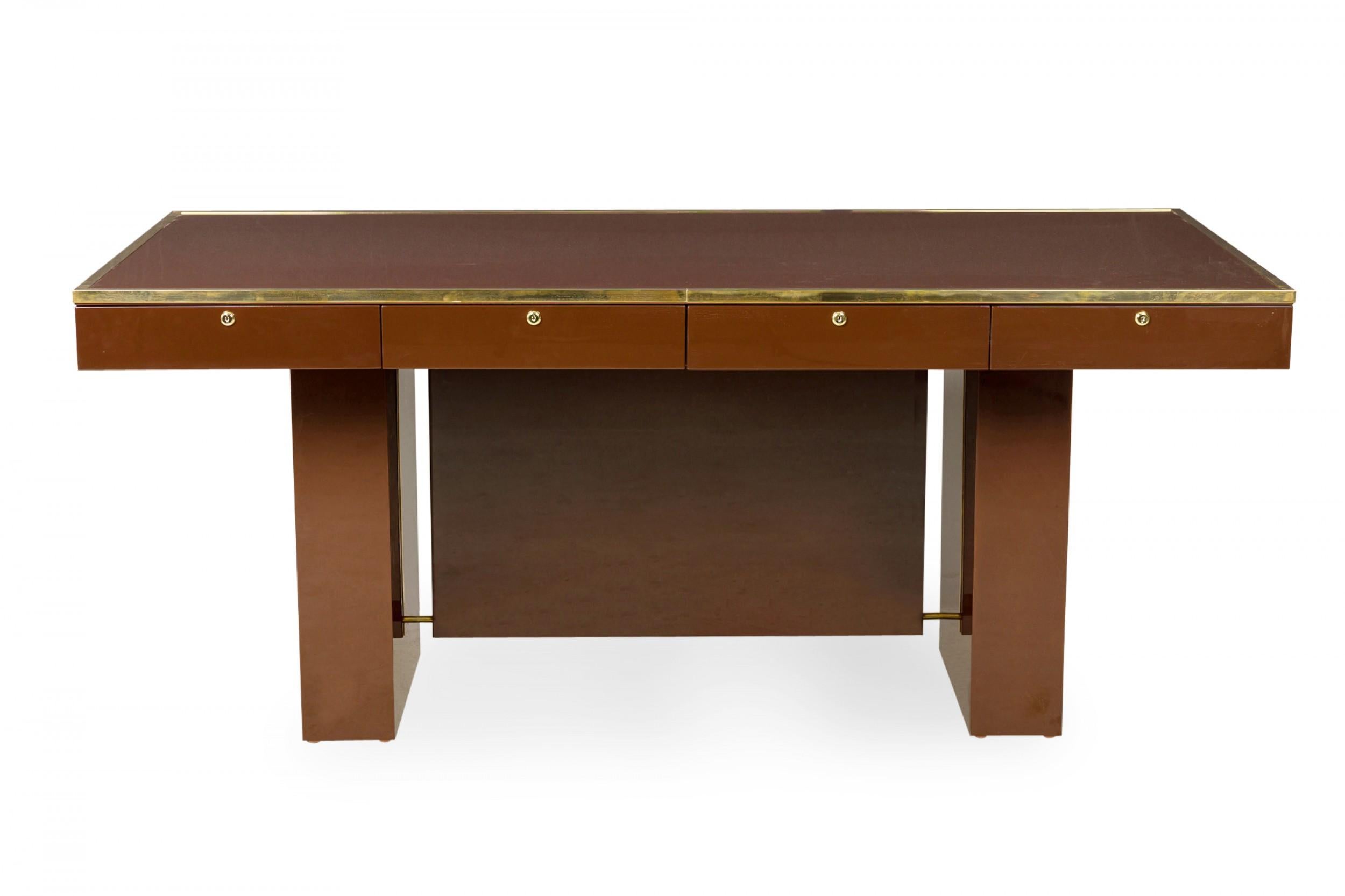Contemporary American lacquered executive desk with brass trimmed edge and 4 drawers supported on 2 rectangular pedestals centering a vanity panel in the style of Aldo Tura.