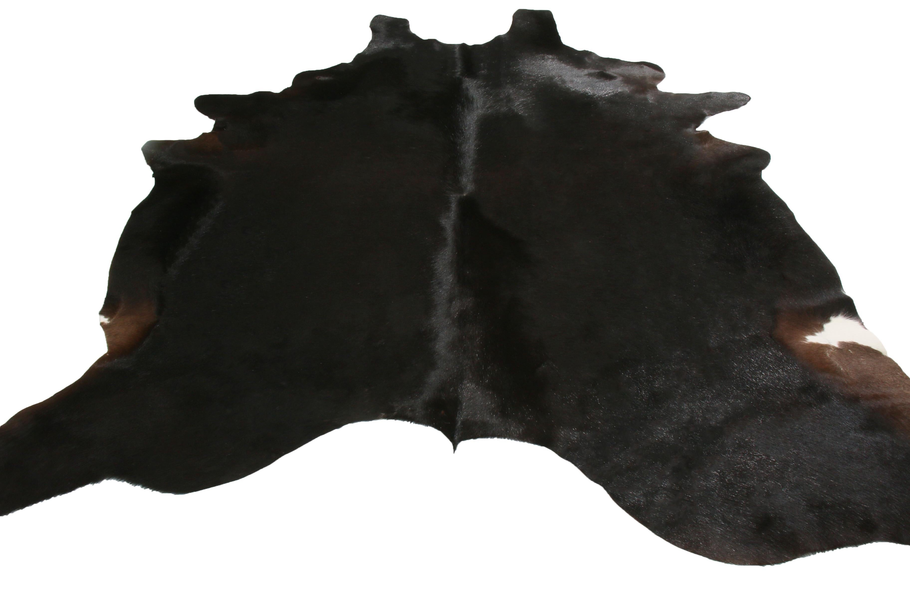 Originating from the United States, this contemporary leather cowhide rug has natural brown and block colorways with minimal beige accents to its hide, a distinguished choice for more luxurious spaces. This tannery maintained the original gentility