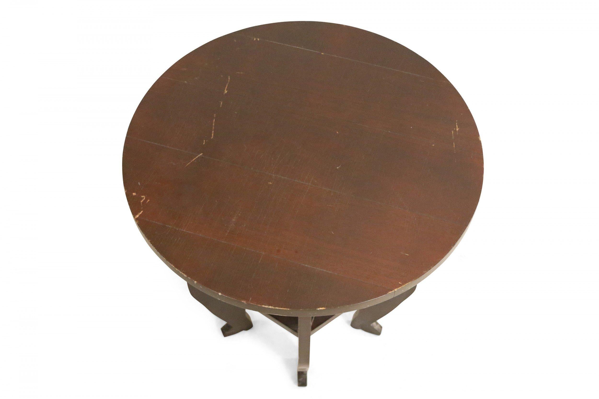 Contemporary wooden end table with a brown painted finish with a circular top and five shaped legs with a lower 5 sided stretcher shelf.
    