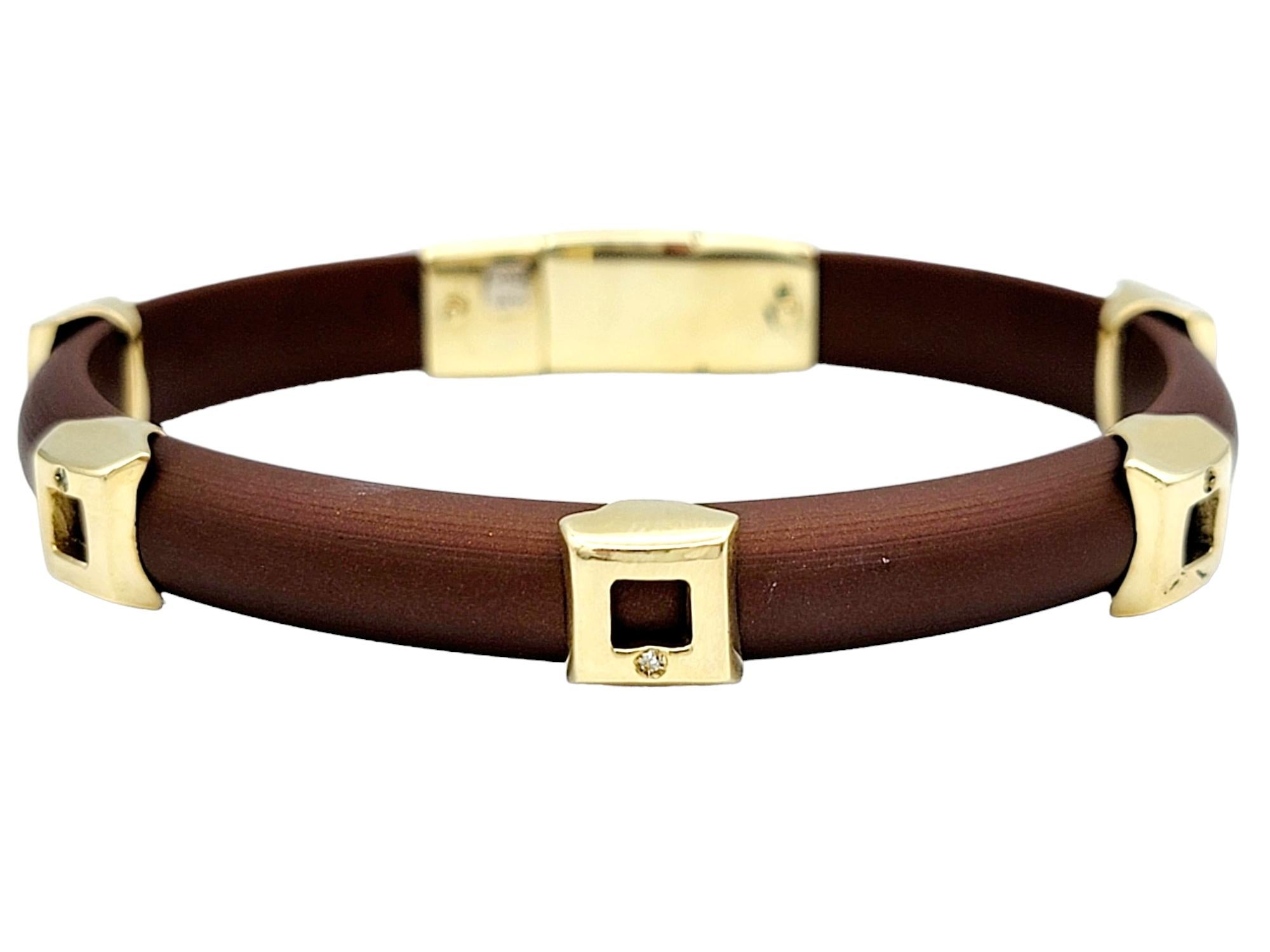This stunning bracelet marries the warmth of 14 karat yellow gold with the contemporary appeal of sleek brown rubber, resulting in a striking and versatile accessory. The bracelet's unique charm lies in its meticulously crafted gold stations, spaced