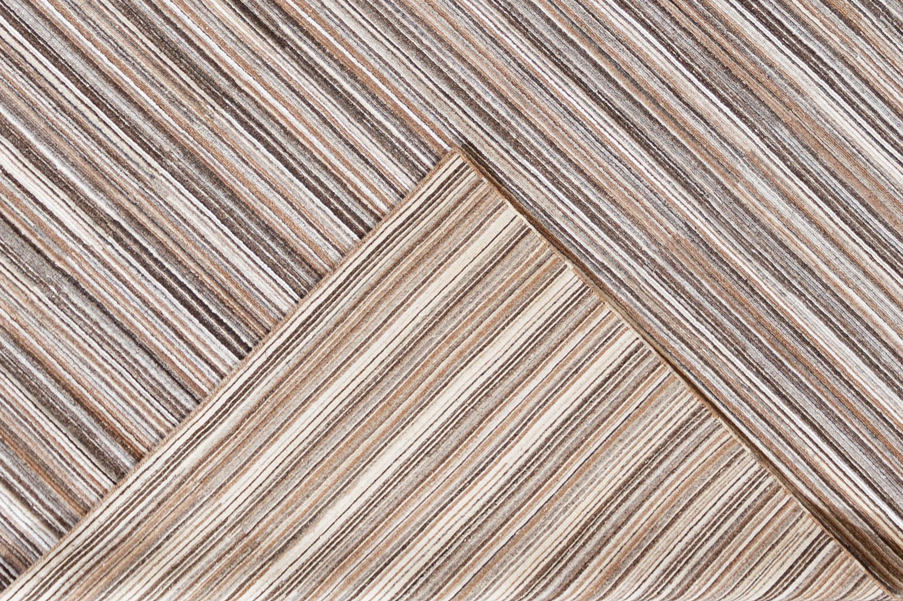 Beautiful contemporary Indian hand-knotted wool and silk rug with alternating brown, ivory, and silver color featuring a gorgeous all-over striped design.


This rug measures 8'2