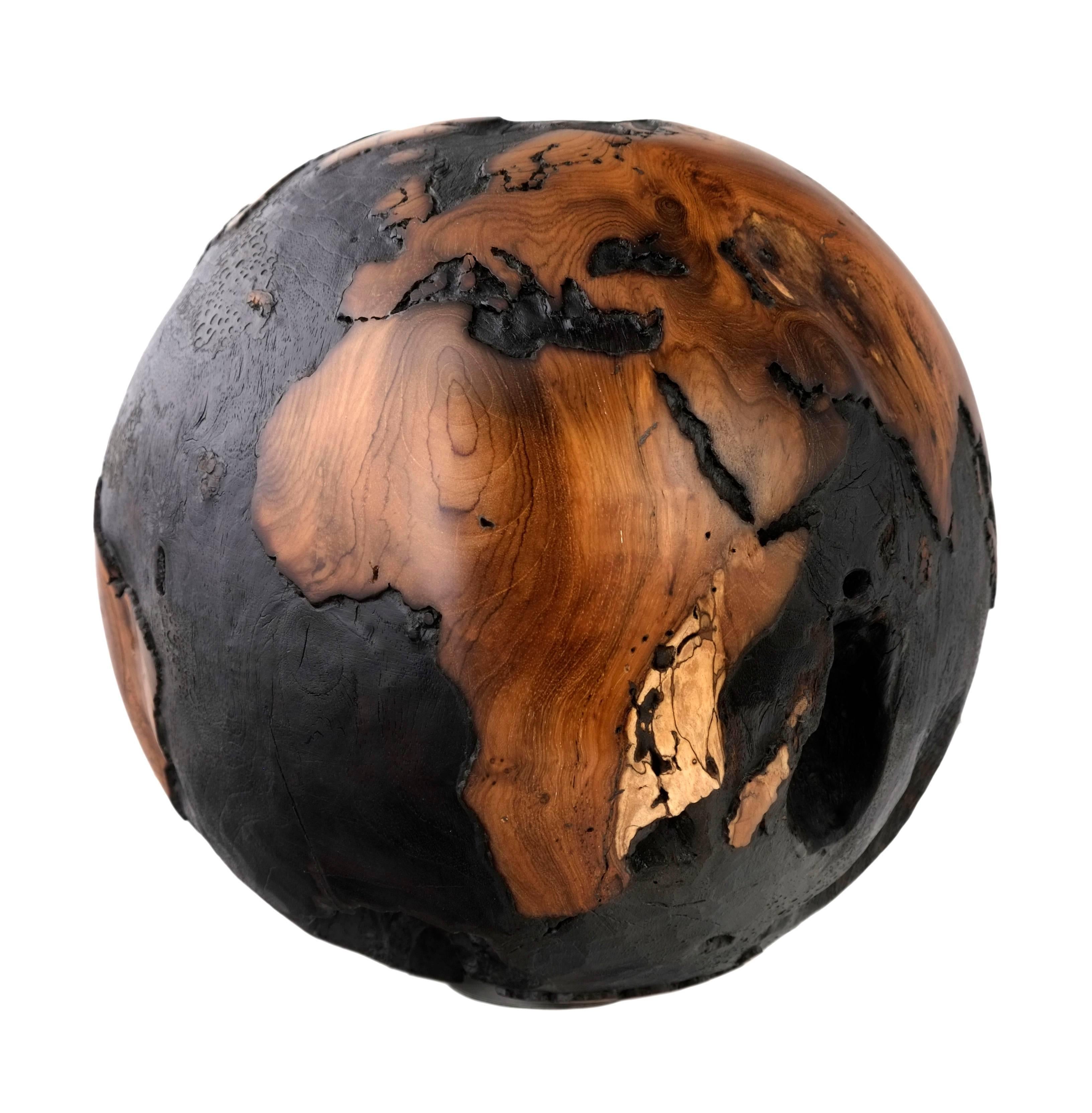 Astonishing hand-carved wooden globe made of reclaimed teak root, iron inlaid on the ocean parts is darken by burning / charring method. 

Dimension: 11.81 inches / 30 cm
Materials: Reclaimed teak root, cold iron layer, black paint, round