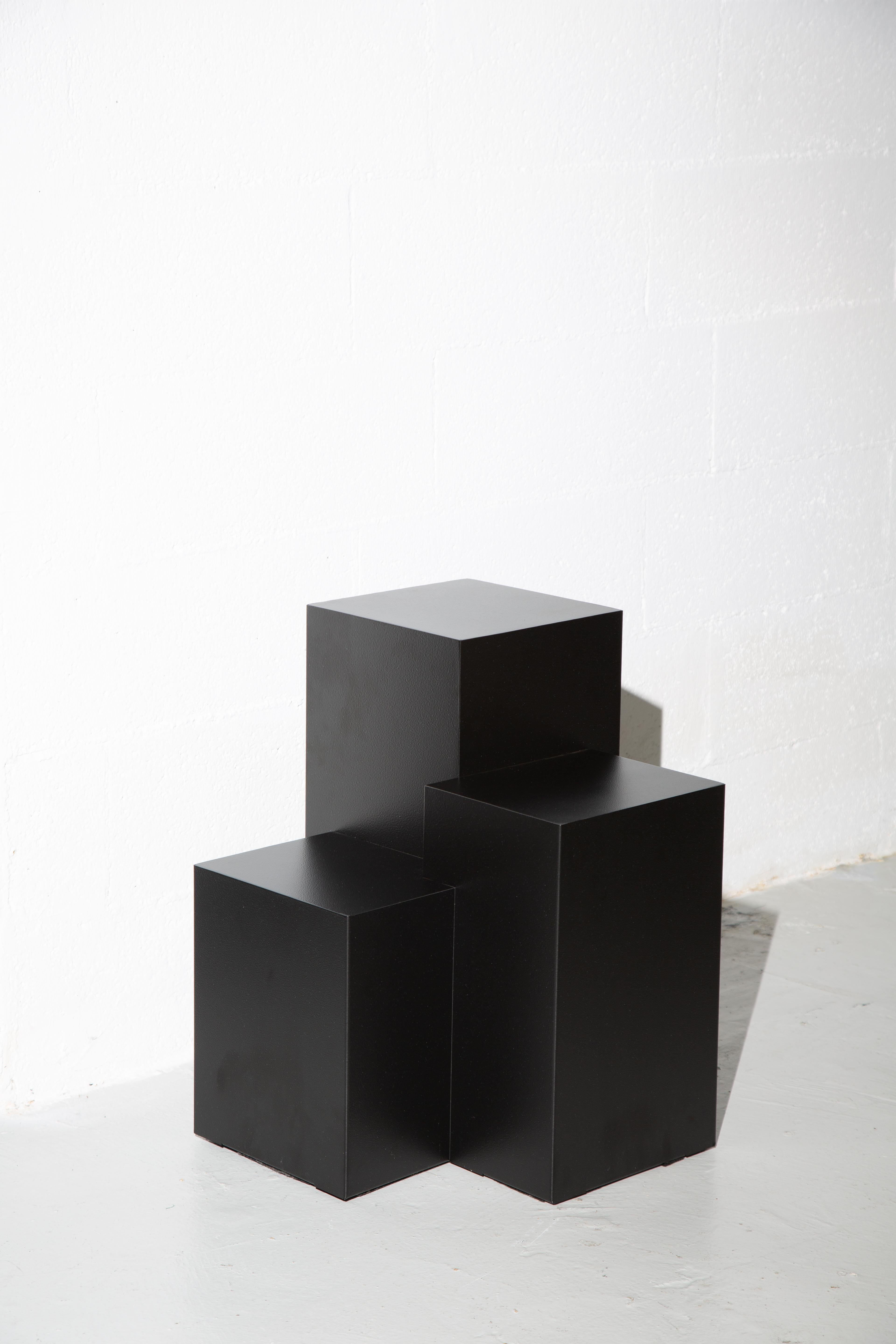 Designed by Spinzi and hand-made in Italy, this essential geometric side table has a strong personality and can easily conjure up images of peaking skylines and towering heights. Sharp and elegant, it is stunning as a plinth for a sculpture, or as a