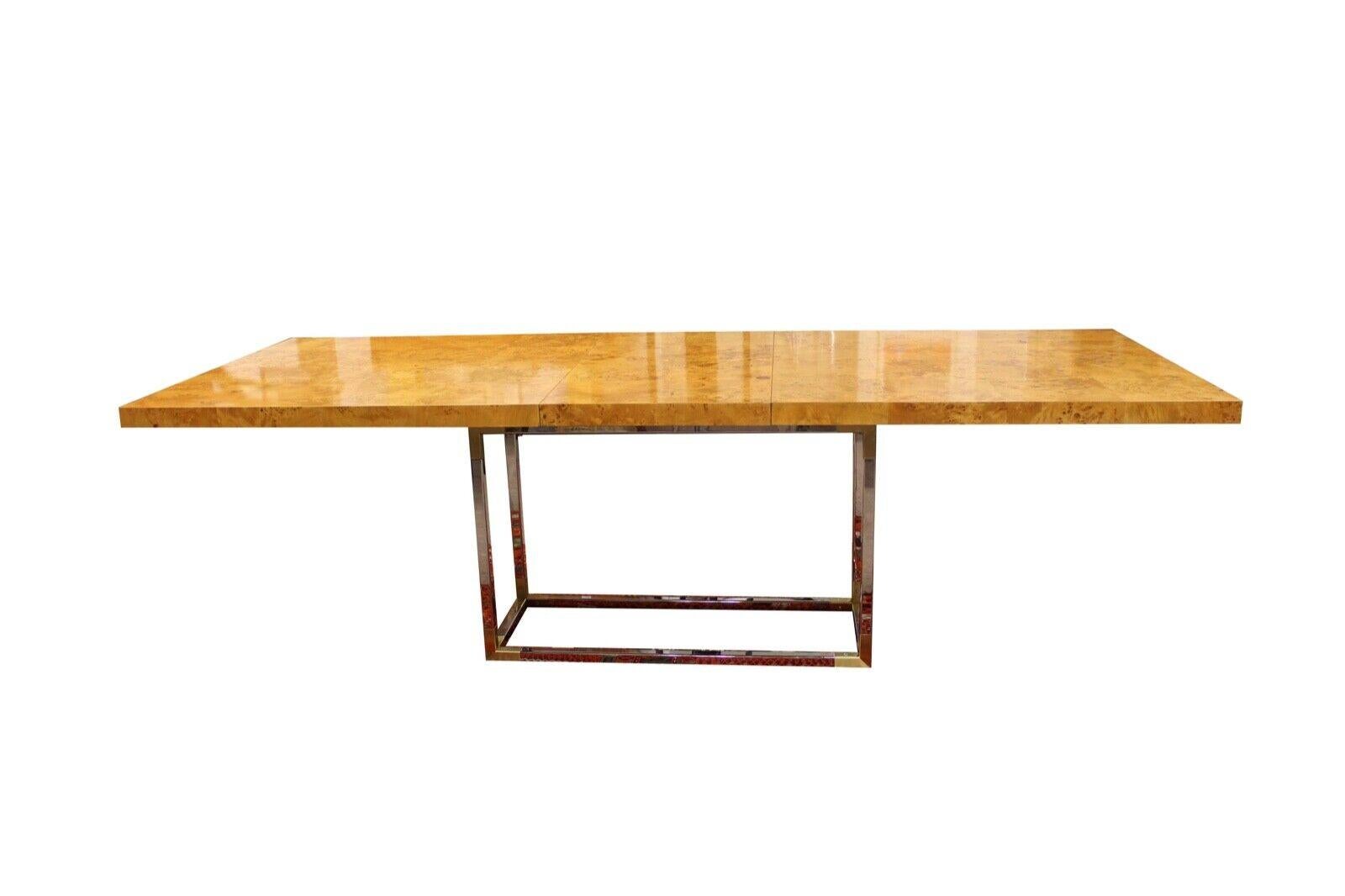 We presents this beautiful Burlwood extendable dining room table with a chrome and brass base. Includes one leaf, designed by Jonathan Adler. In very good condition. Dimensions: 80