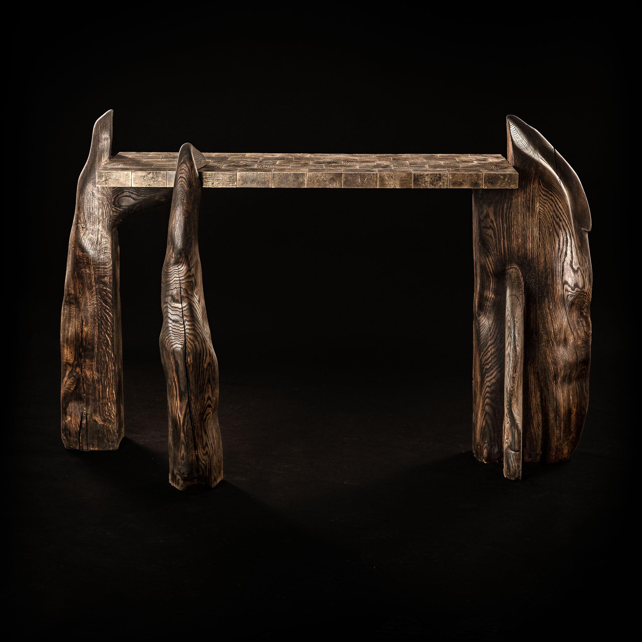 Console table with own produced handcast brass tiles combined with handsculpted oak bases. Inspired by the statical and mysterious monument Stonehenge this console table is both organic and aligned.

graduated as a cooling engineer, tanguy