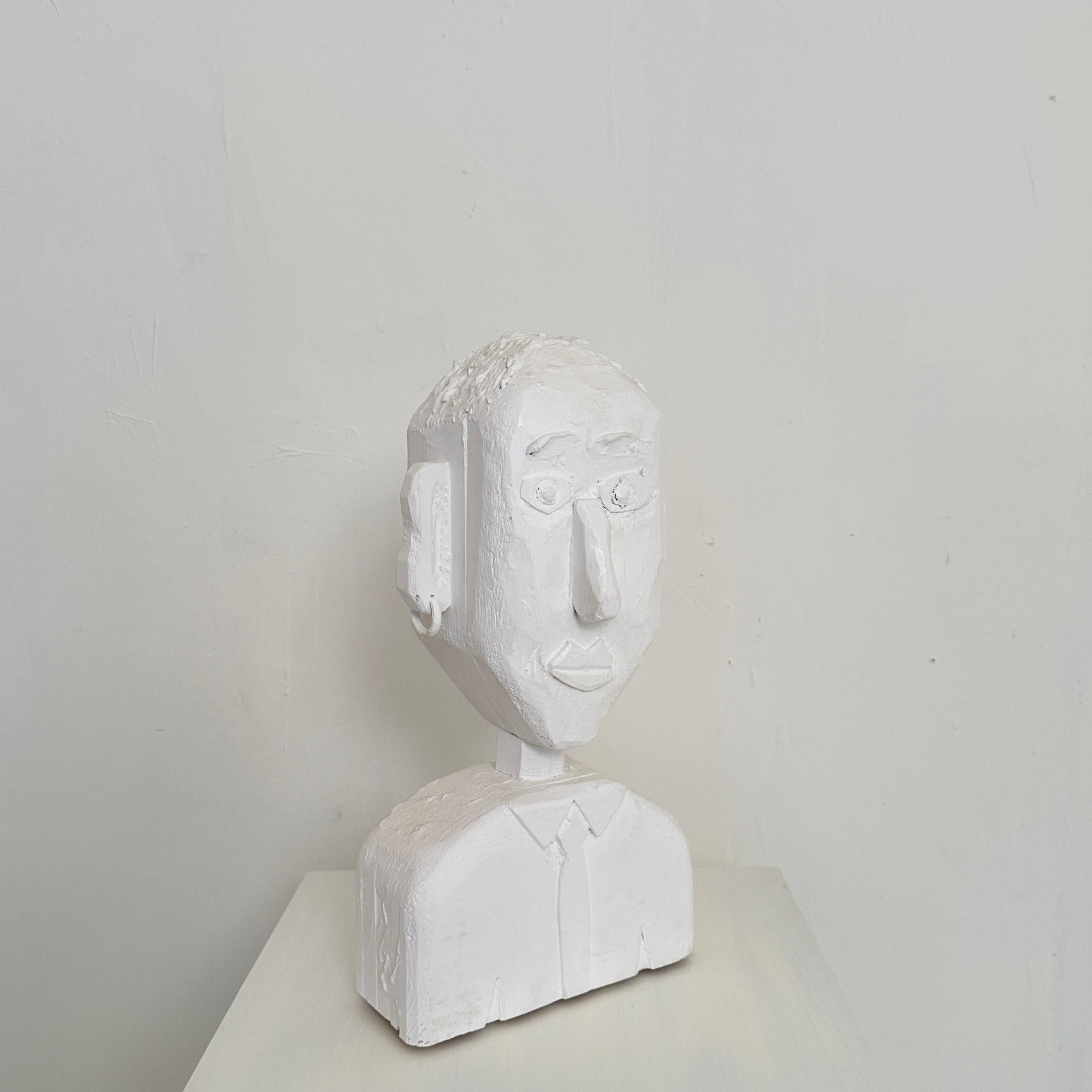 Crafted in 2023, the Contemporary Bust of a Man breathes life into the age-old tradition of sculptural expression. Hewn from pine, its form emerges from the raw essence of nature, carved with precision and imbued with modern artistic vision. The