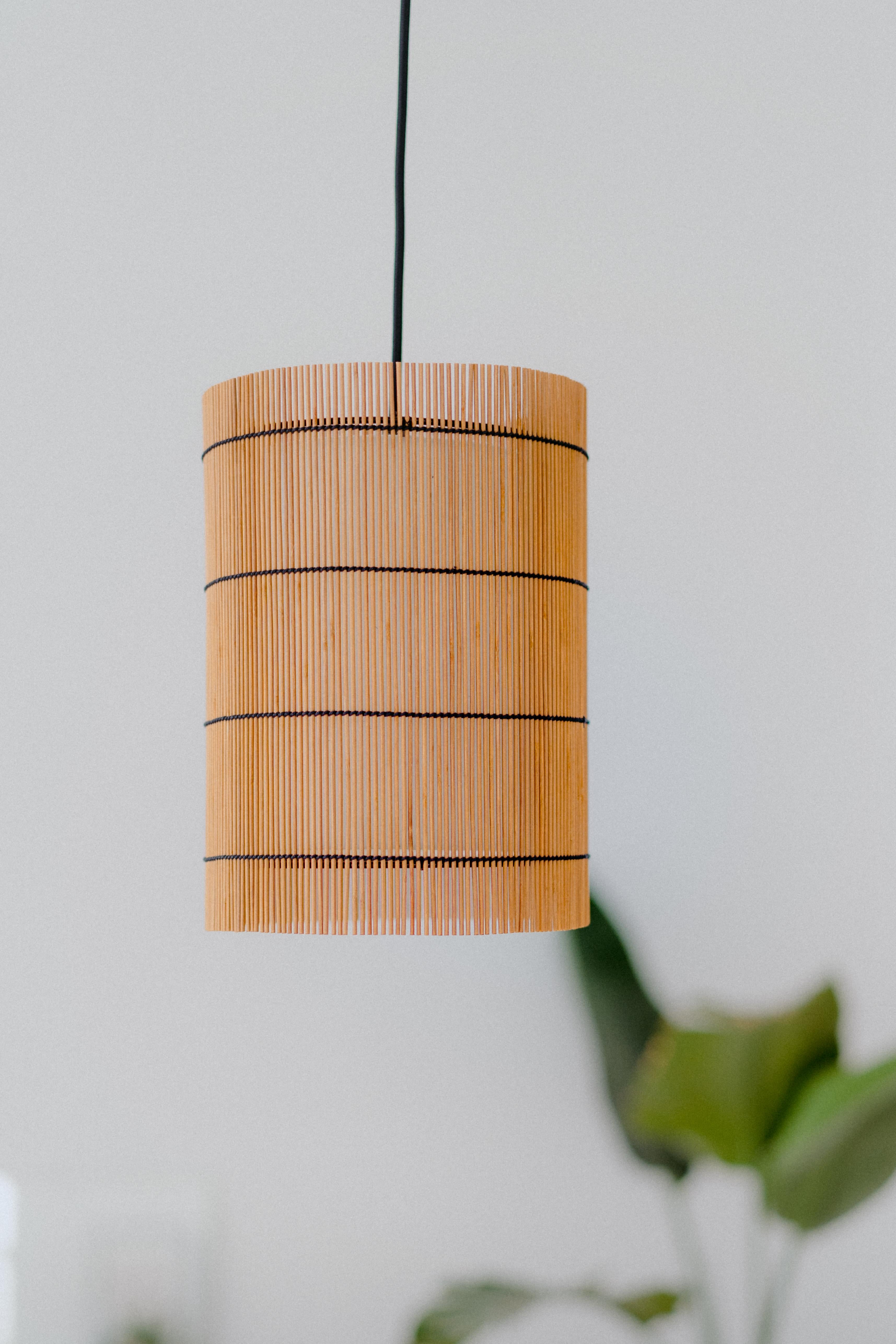 FOC lamps are designed and manufactured by Mediterranean Objects in Barcelona, Spain. 

They consist of an outer shade of cherry-colored dyed bamboo, interwoven with a black thread, just like the structure of the lamp. This lampshade gives a unique