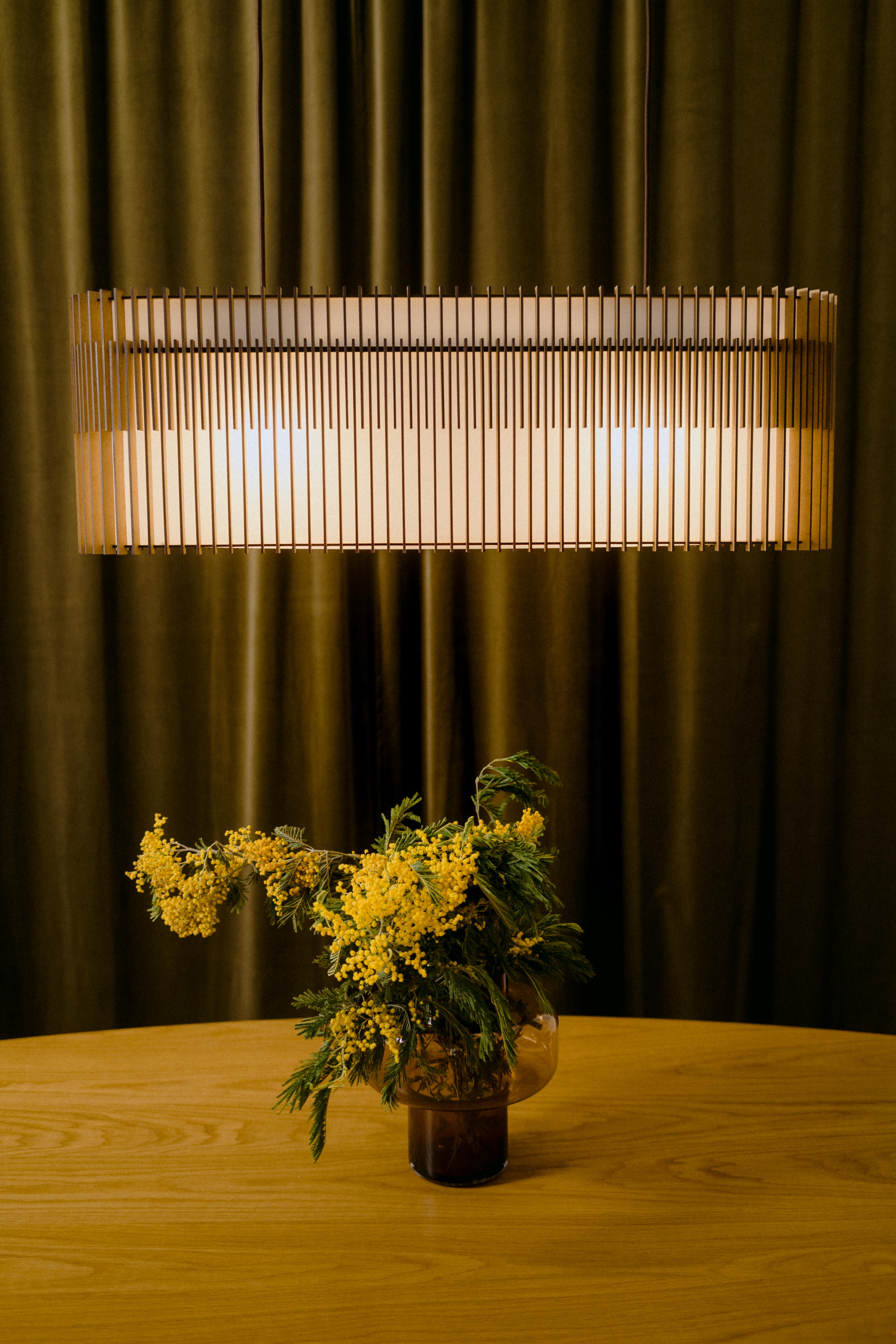 SUAU
Pendant lamp
THE FAMILY:

SUAU lamps are designed and manufactured by Mediterranean Objects in Barcelona, Spain. 
They have an outer lampshade made of MDF wooden slats, laser-cut and assembled one by one, creating two different visual textures,