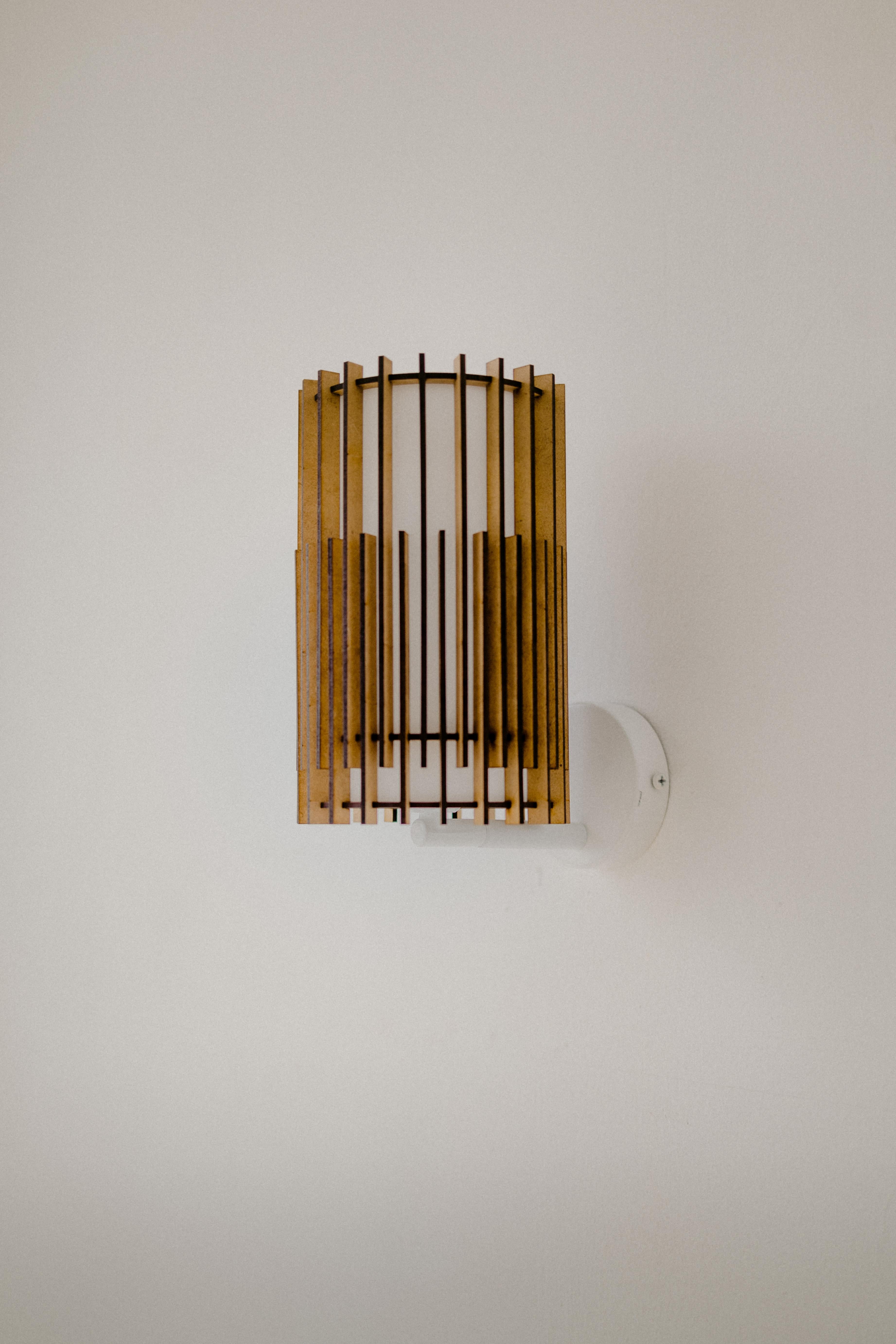 SUAU lamps are designed and manufactured by Mediterranean Objects in Barcelona, Spain. 

They have an outer lampshade made of MDF wooden slats, laser cut and assembled one by one, creating two different visual textures, one more dense and the other
