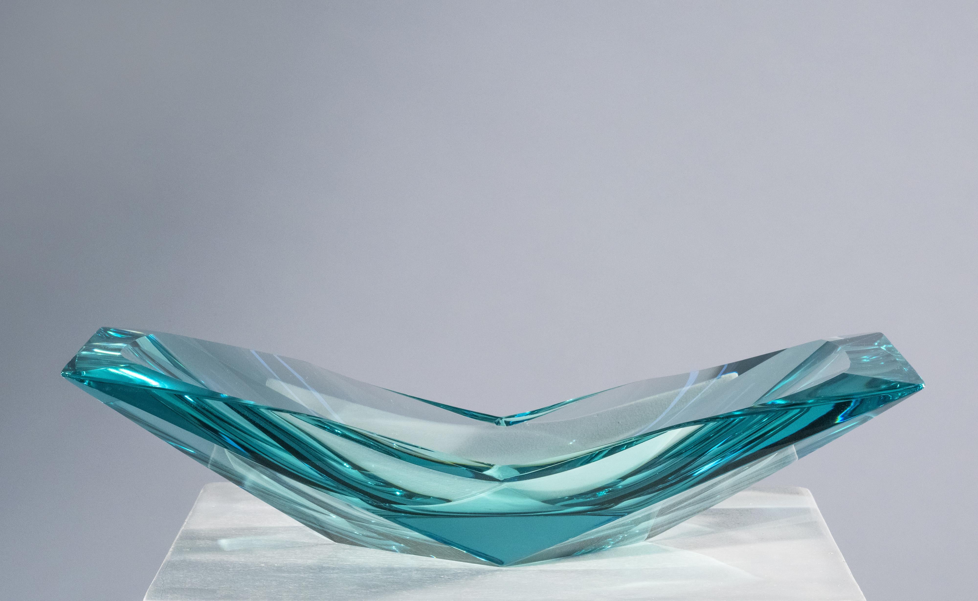 
Innovative design, fine craftsmanship and a strong artistic sense make this creation not only a bowl but a real artistic sculpture. The natural color of the crystal is acquamarine-like. It has a thick of twentyfive mm and has been hand-worked to