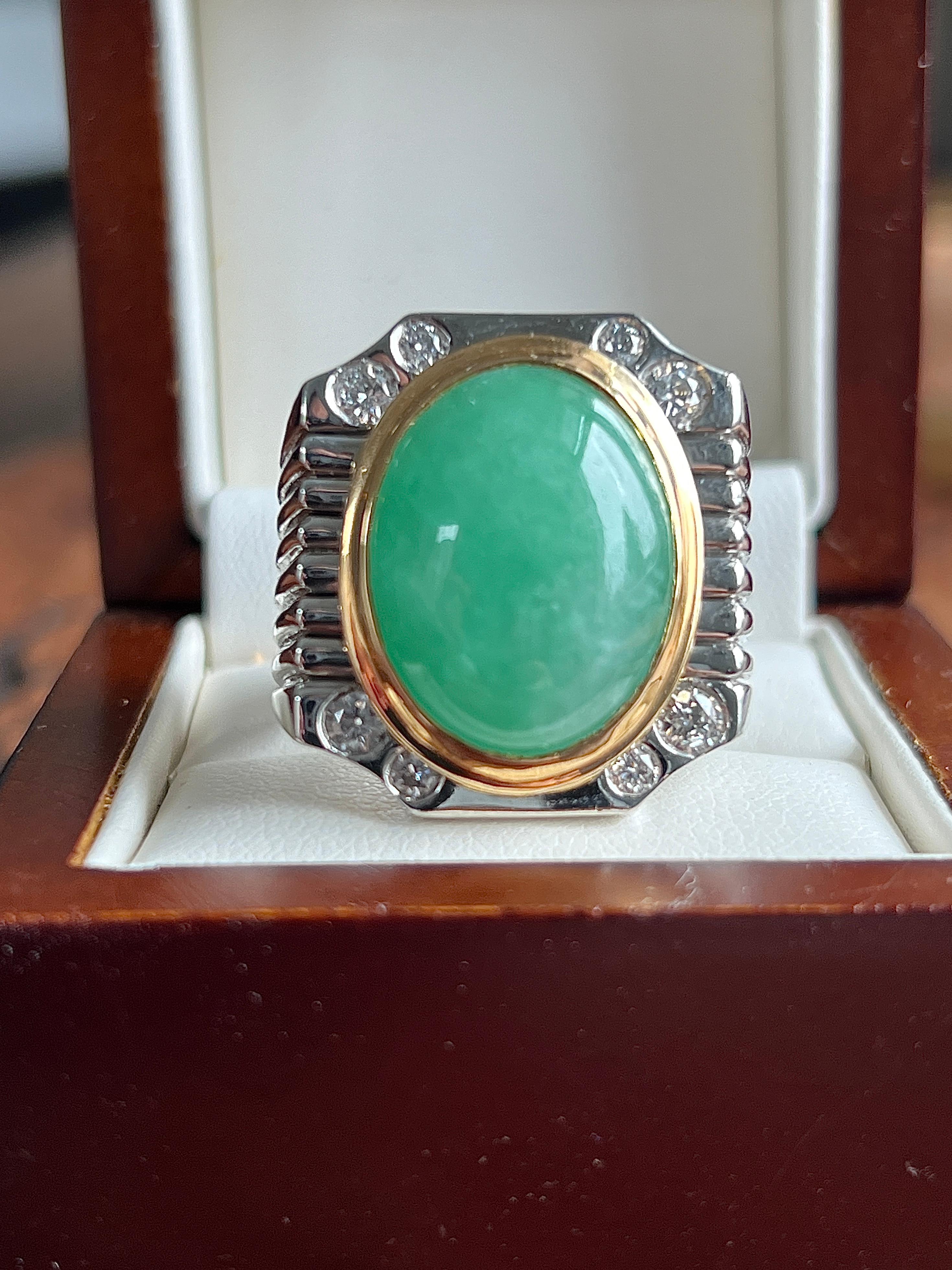 This bold contemporary men’s statement ring is expertly crafted in solid platinum with an 18K yellow gold bezel, creating a striking contrast that highlights its luxurious design. At the center, a captivating 20 x 15mm cabochon jadeite is securely