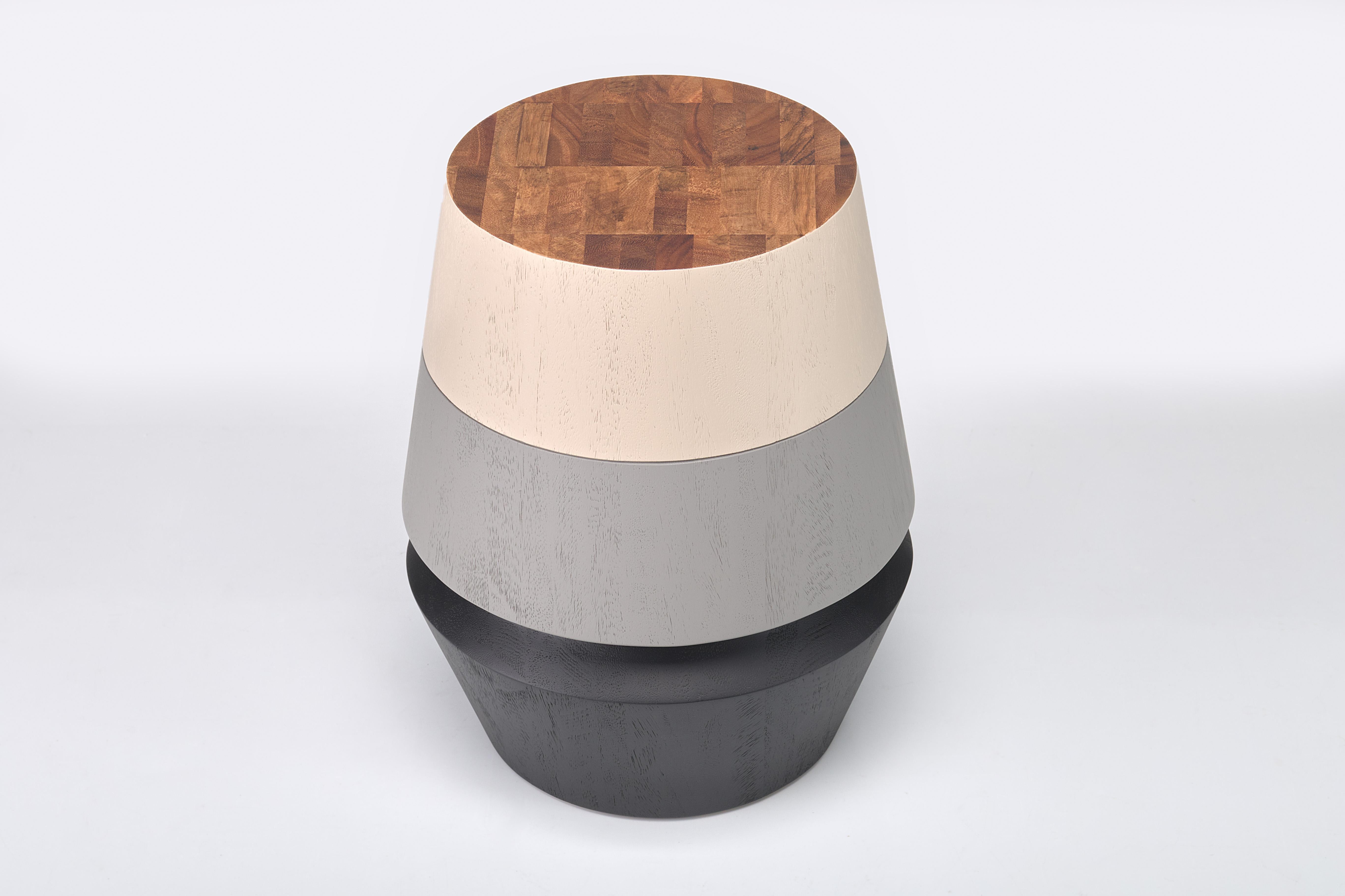 The capirucho side table and stool are inspired by a popular yet simple toy enjoyed for many generations by kids in Guatemala. The piece has a playful Silhouette turned with conacaste, and it can be accentuated with colorful bands creating a more