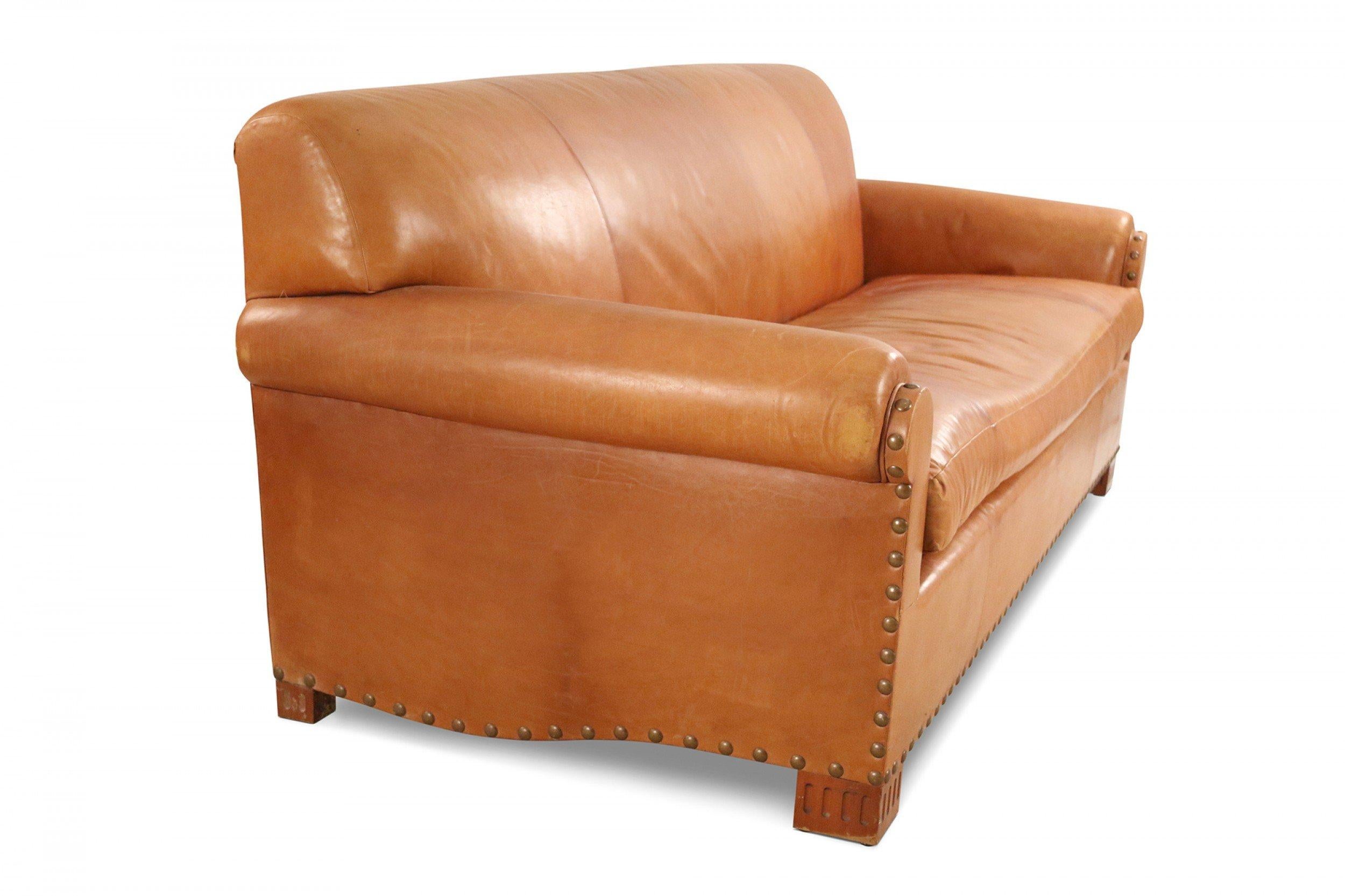 Contemporary caramel brown leather 3-seat sofa with brass upholstery nail trim, removable single cushion seat with square wooden legs.
