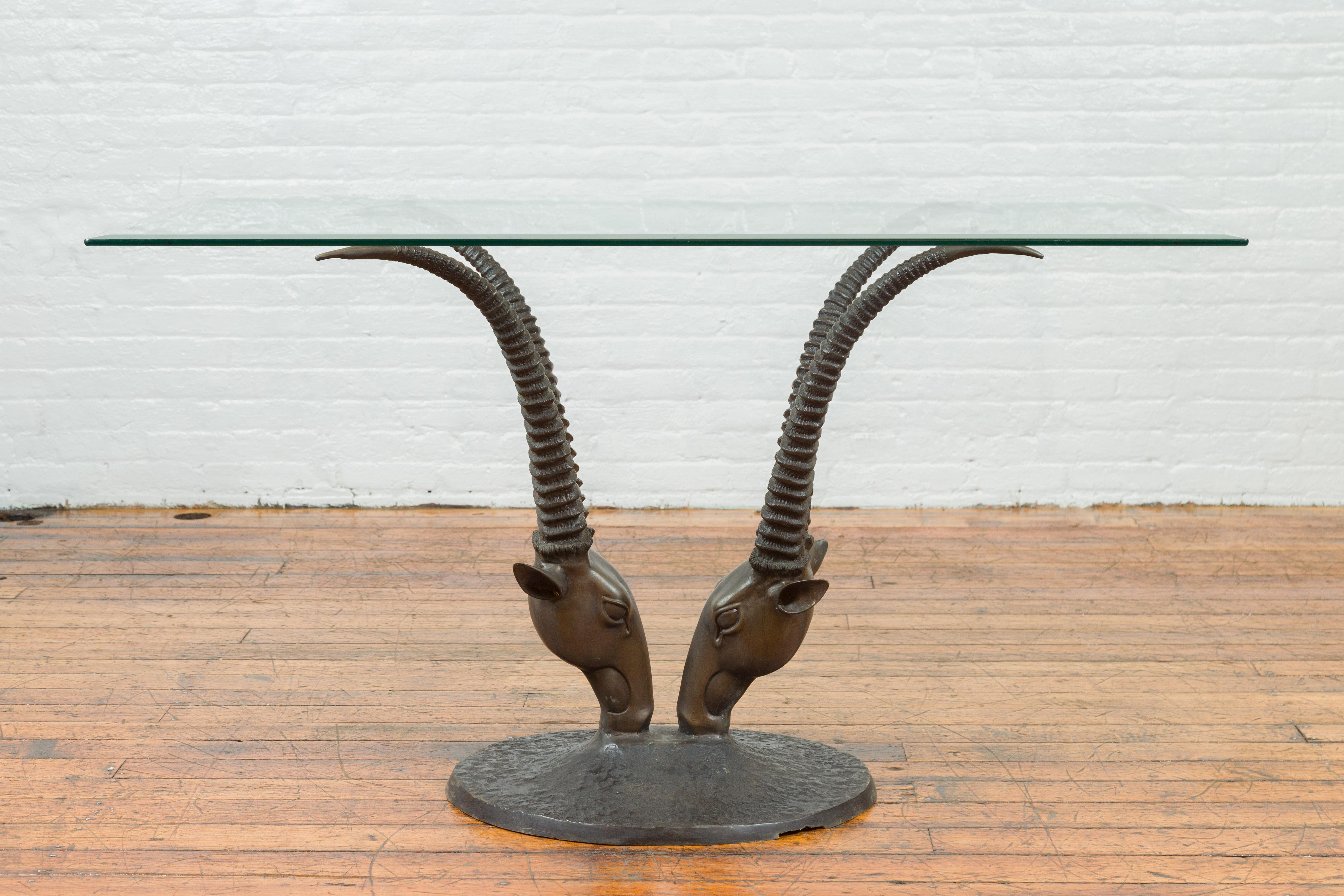 A contemporary bronze double antelope dining table base, top not included. Created with the traditional technique of the lost-wax (à la cire perdue) that allows a great precision and finesse in the details, this contemporary bronze dining table base