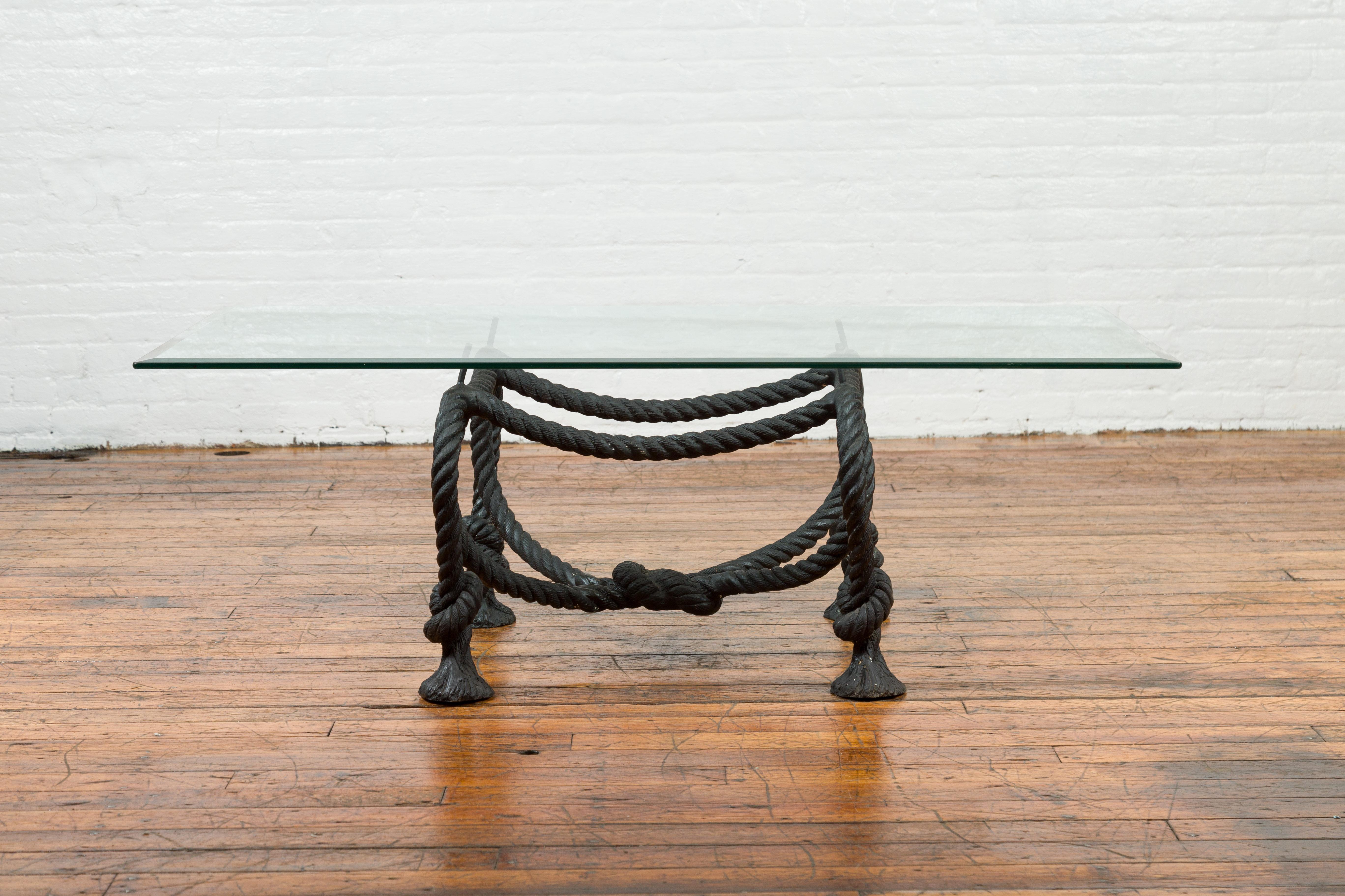 A bronze coffee table base in the manner of Maison Jansen, with nautical rope theme, tassels and dark patina. Crafted with the traditional lost-wax method (à la cire perdue) that ensures remarkable precision and exquisite detailing, this bronze