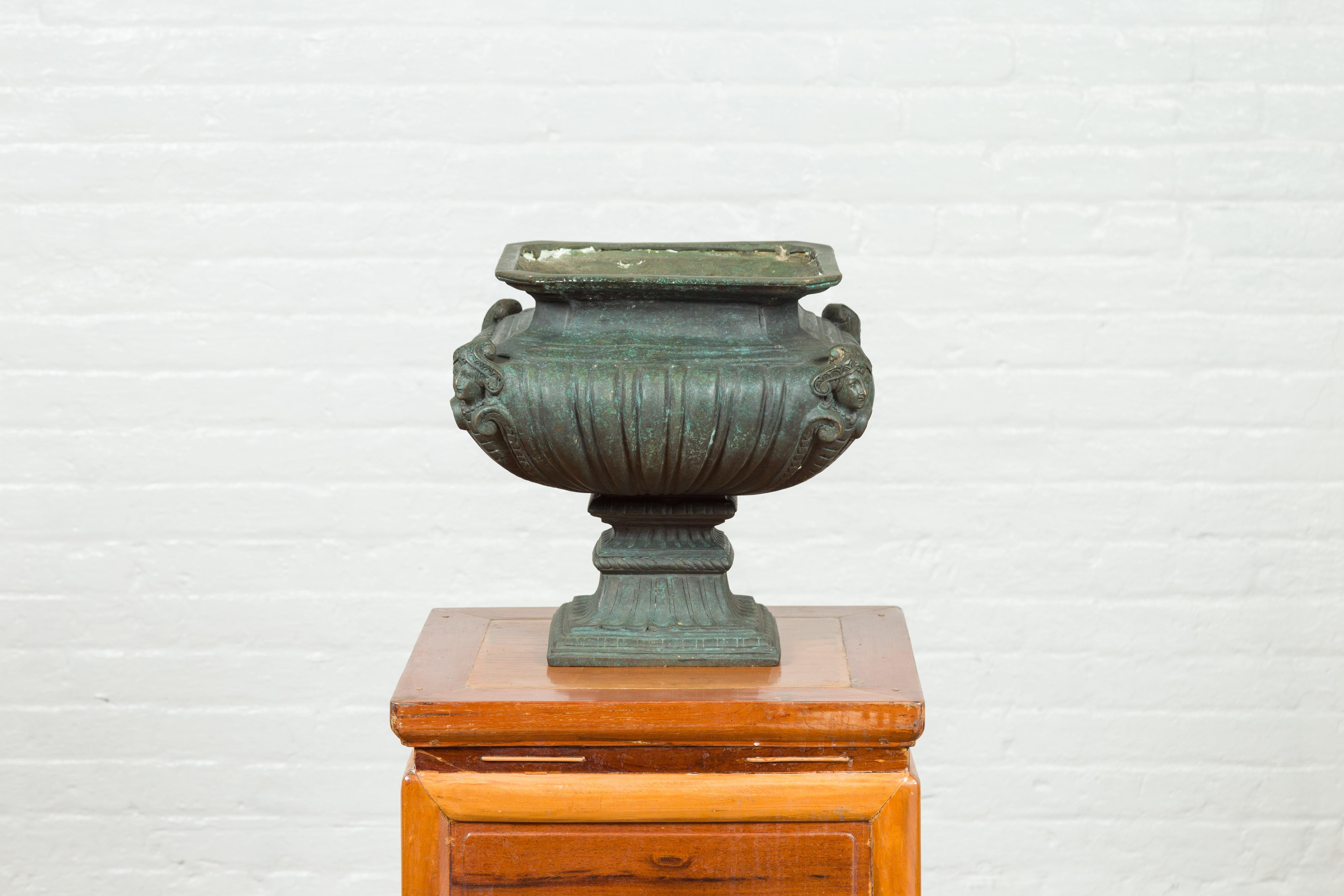 A contemporary verde bronze planter with figures and gadroon motifs. Created with the traditional technique of the lost-wax (à la cire perdue) that allows a great precision in the details, this contemporary planter features a square top with canted