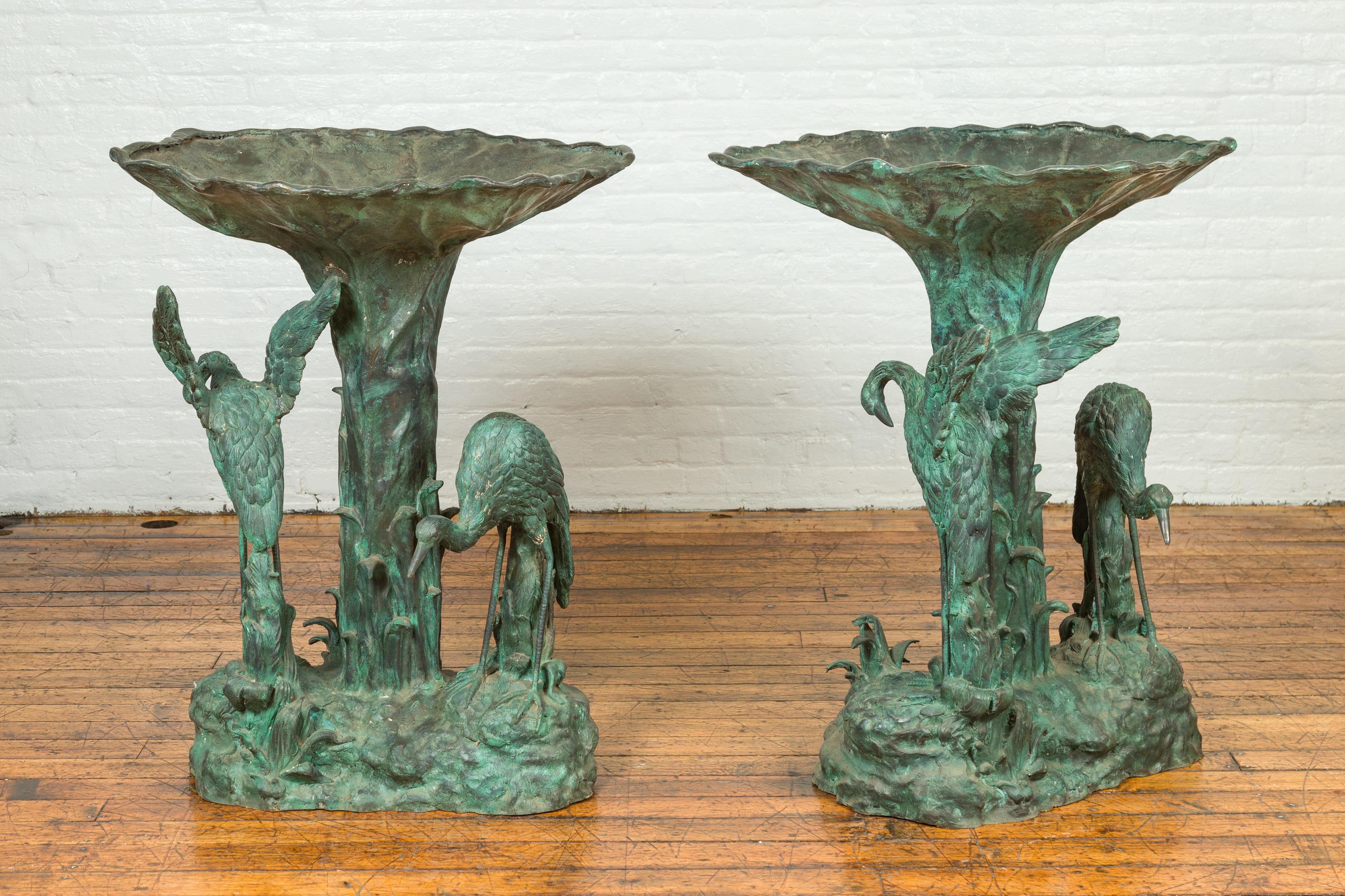 Update - Only one planter is available for sale.
Contemporary cast bronze planter with cranes on the base and verdigris patina, priced and sold individually. Created with the traditional technique of the lost-wax (à la cire perdue) that allows a