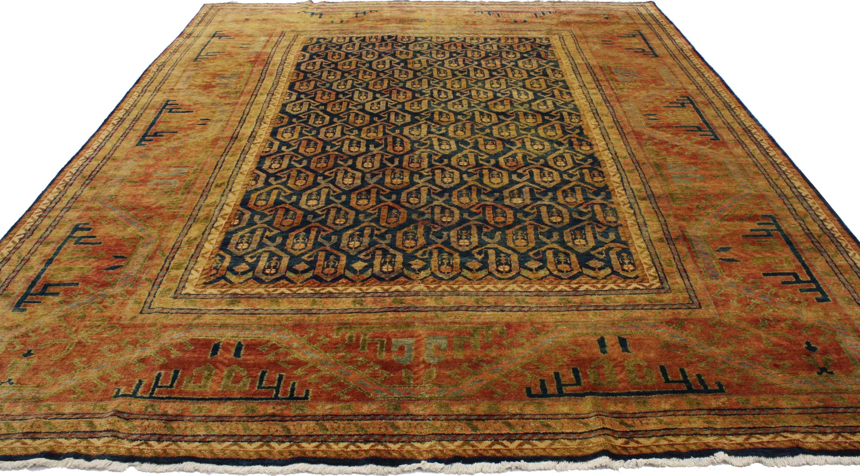 30193, contemporary Caucasian and Kazak style area rug. This hand knotted wool contemporary Caucasian and Kazak style rug features an all-over floral boteh pattern spread across an abrashed ink blue field. The widely used boteh motif is thought to