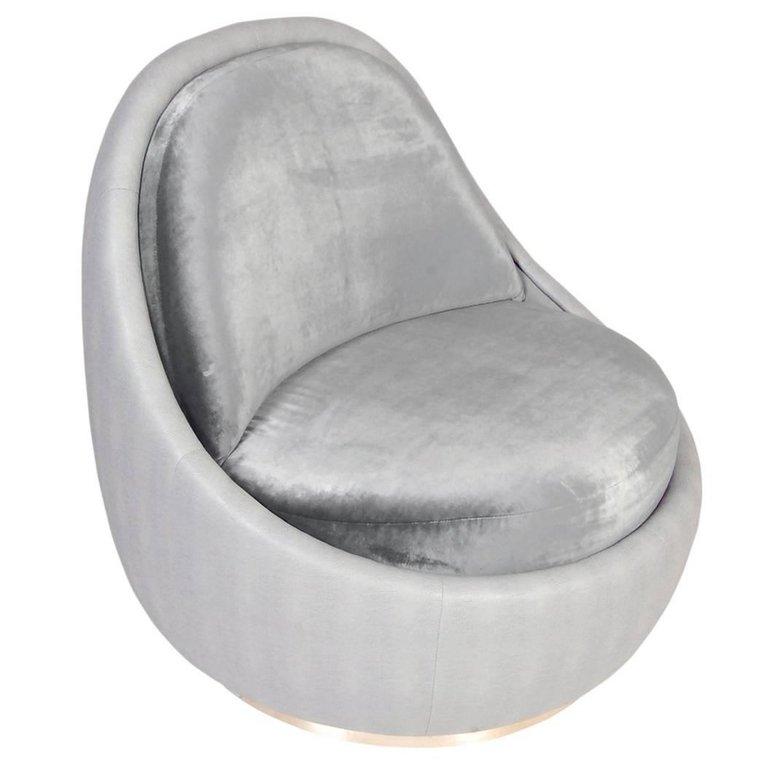 The 'Cup' is a fully upholstered occasional chair mounted on a circular ribbon metal base. Deeply cushioned for great comfort with the clean organic lines and modernist styling providing a playful yet timeless design.