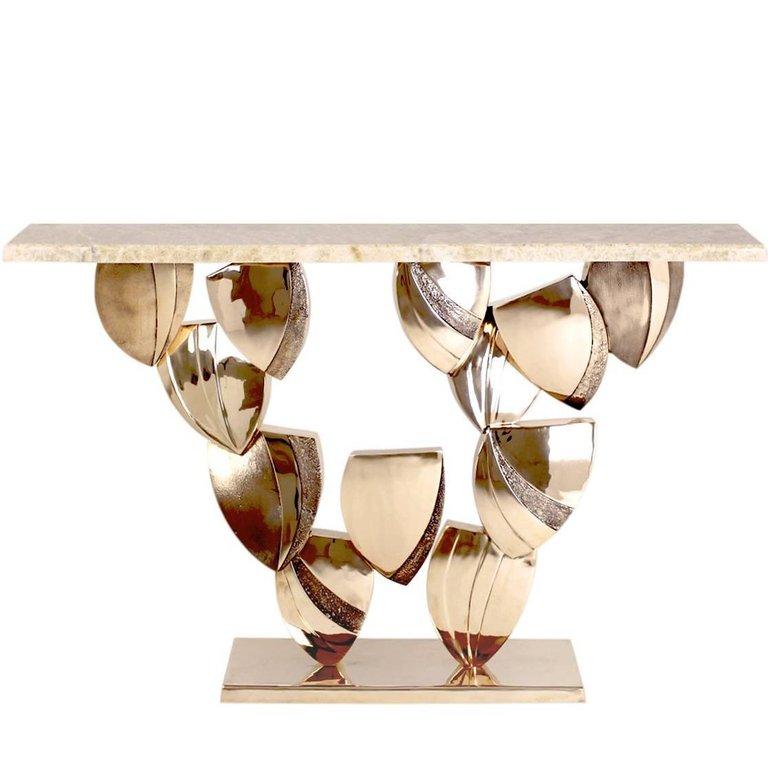 The striking forms of the petal console table are created by the careful arrangement of individual cast pale brass ‘petal’ like pieces in four different textured finishes that are arranged to appear to be gently falling beneath the amber onyx top.