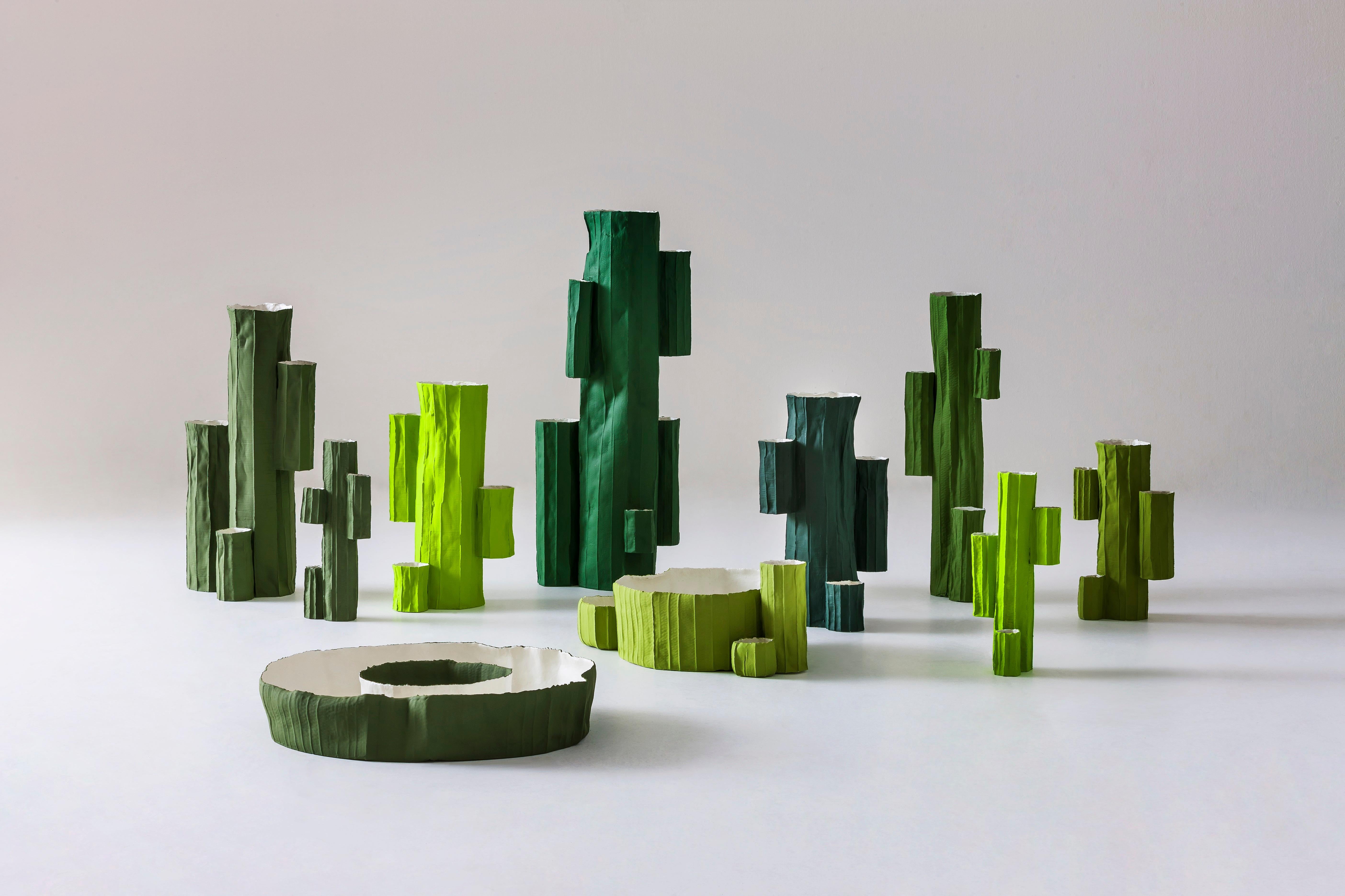 This unique vase was handcrafted using paper clay, a clay-base mixture enriched with natural fibers. The final firing phase results in the distinctive, light-yet-strong appearance and captivating look. Handcrafted and hand painted in vivid green,